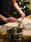 Hands filling small dough circles with filling.