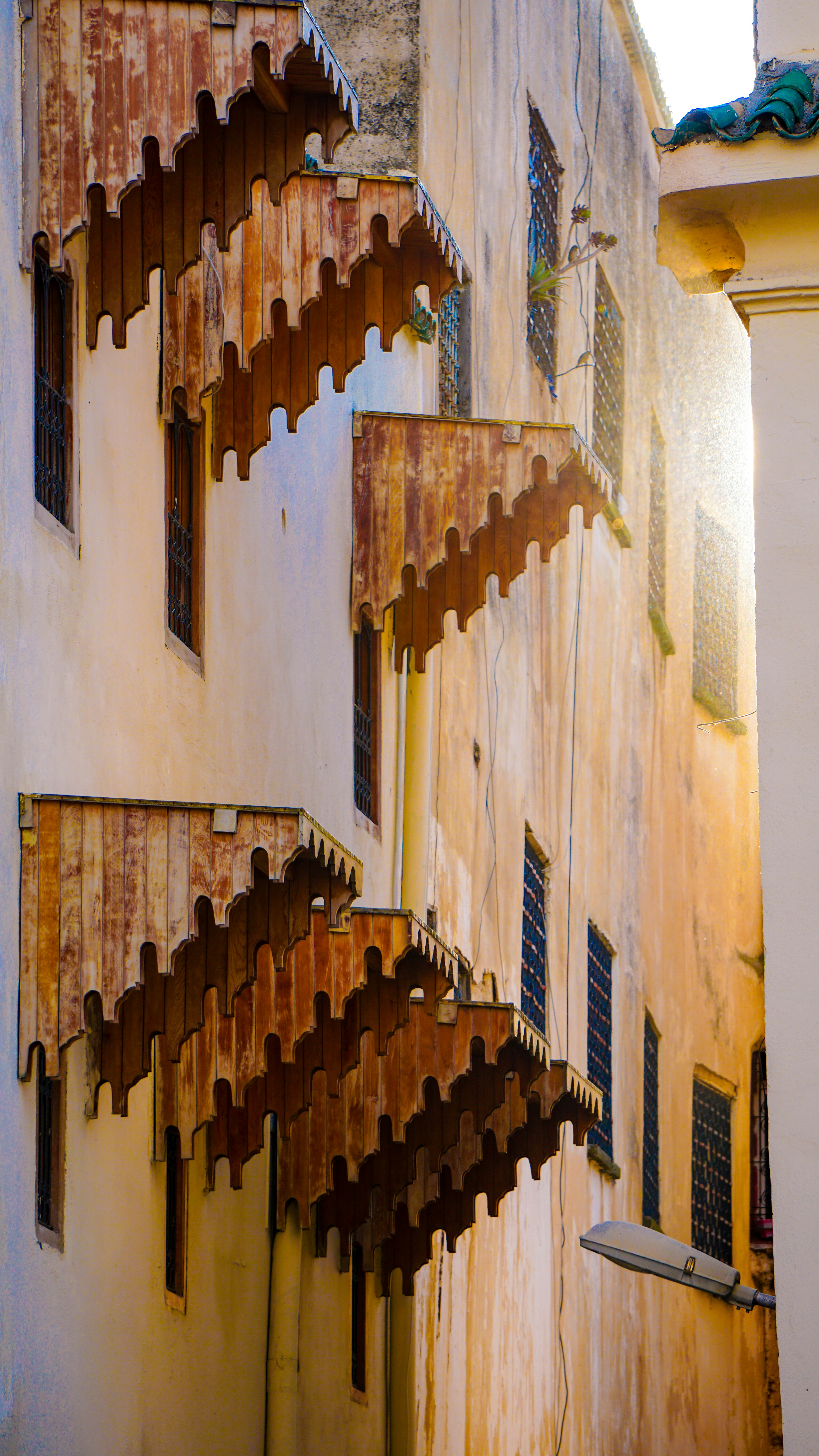 Ornate wooden balconies on a weathered building facade.