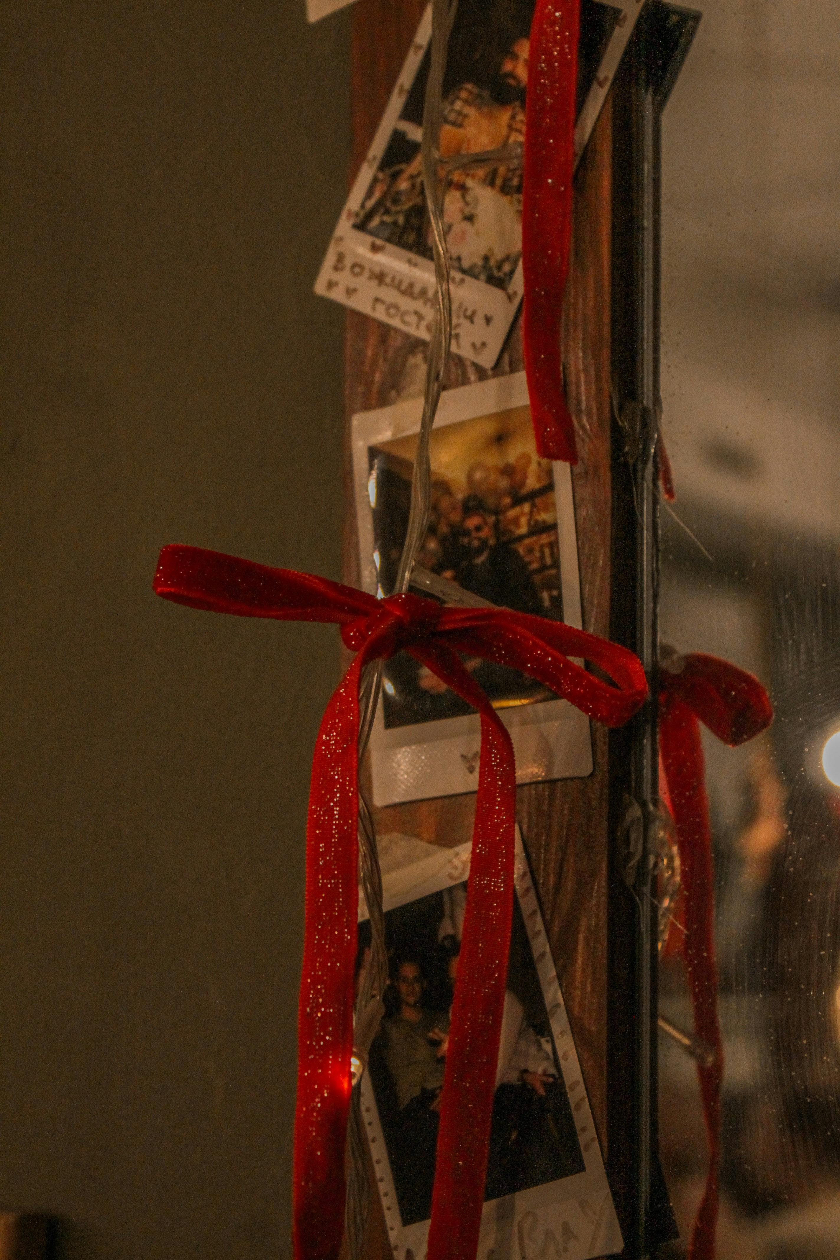 Instant photos with red ribbon and lights