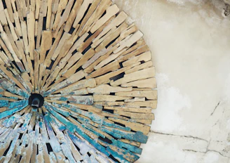 Circular stone mosaic with blue accents on wall