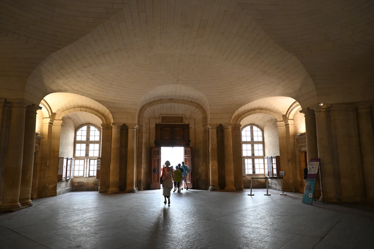 Stone arcade, daylight beyond. Illustrative editorial image, not a photograph of Surcee's.