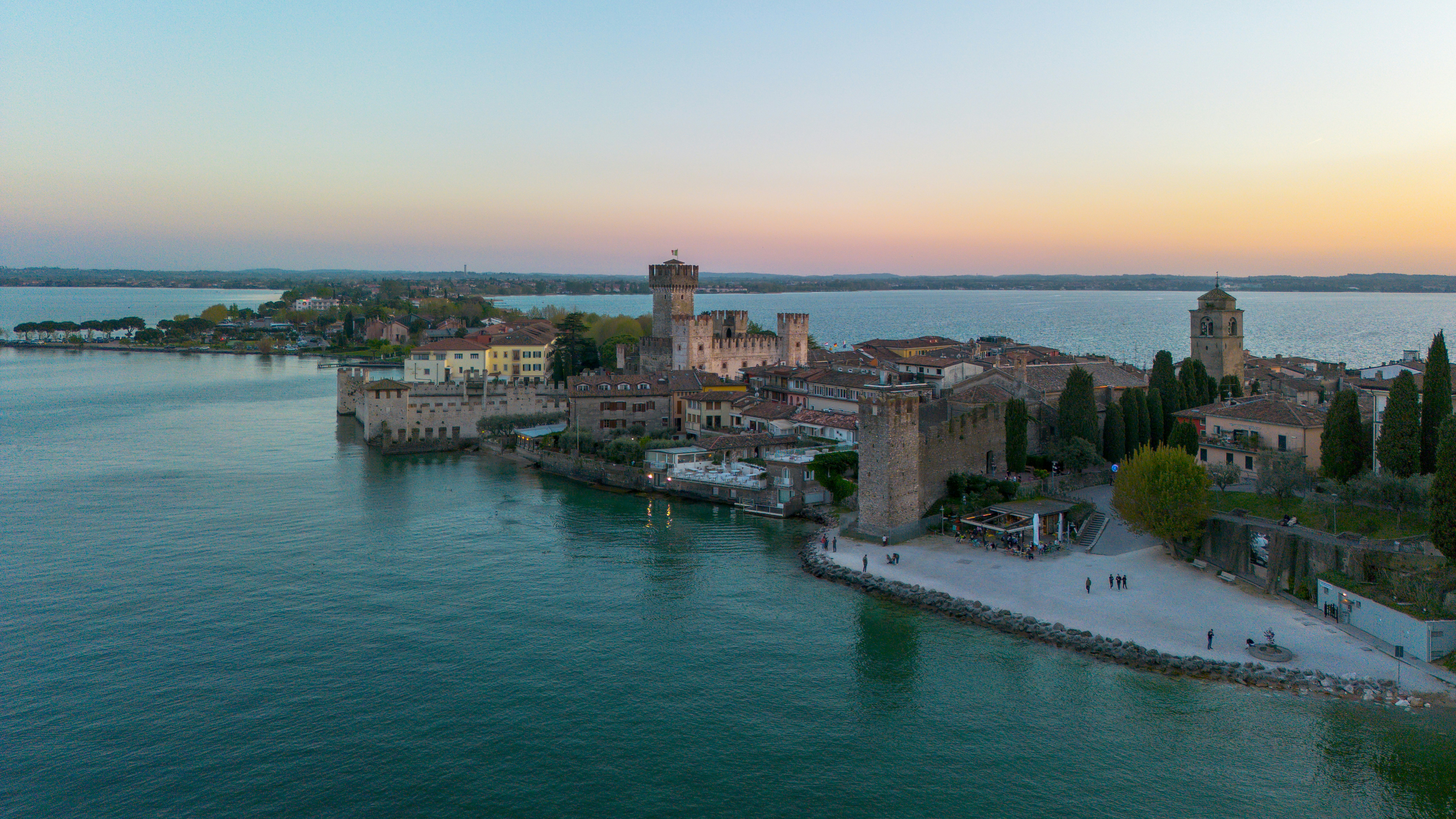 Castle on a peninsula at sunset over the lake.