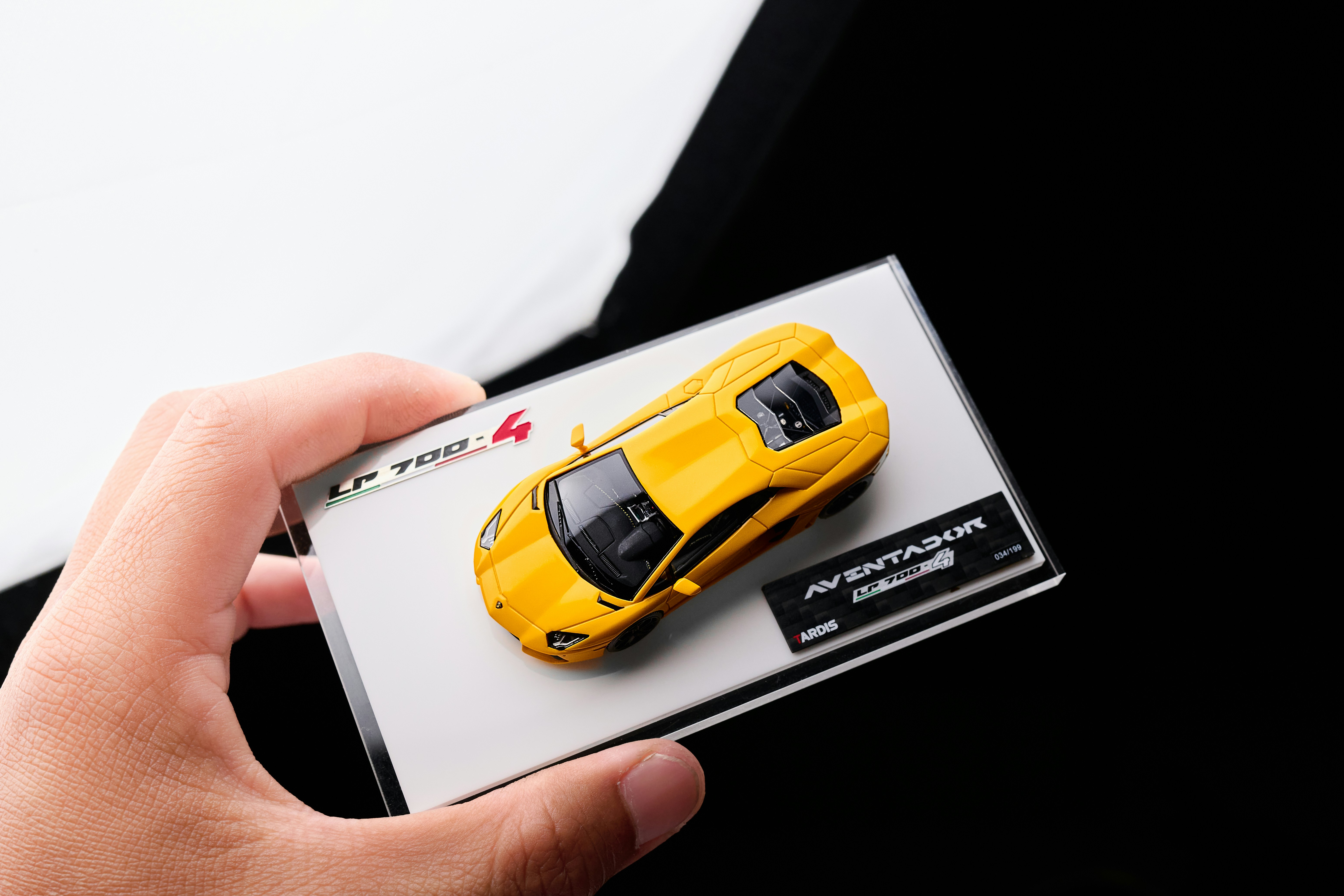 Yellow toy sports car in packaging held box