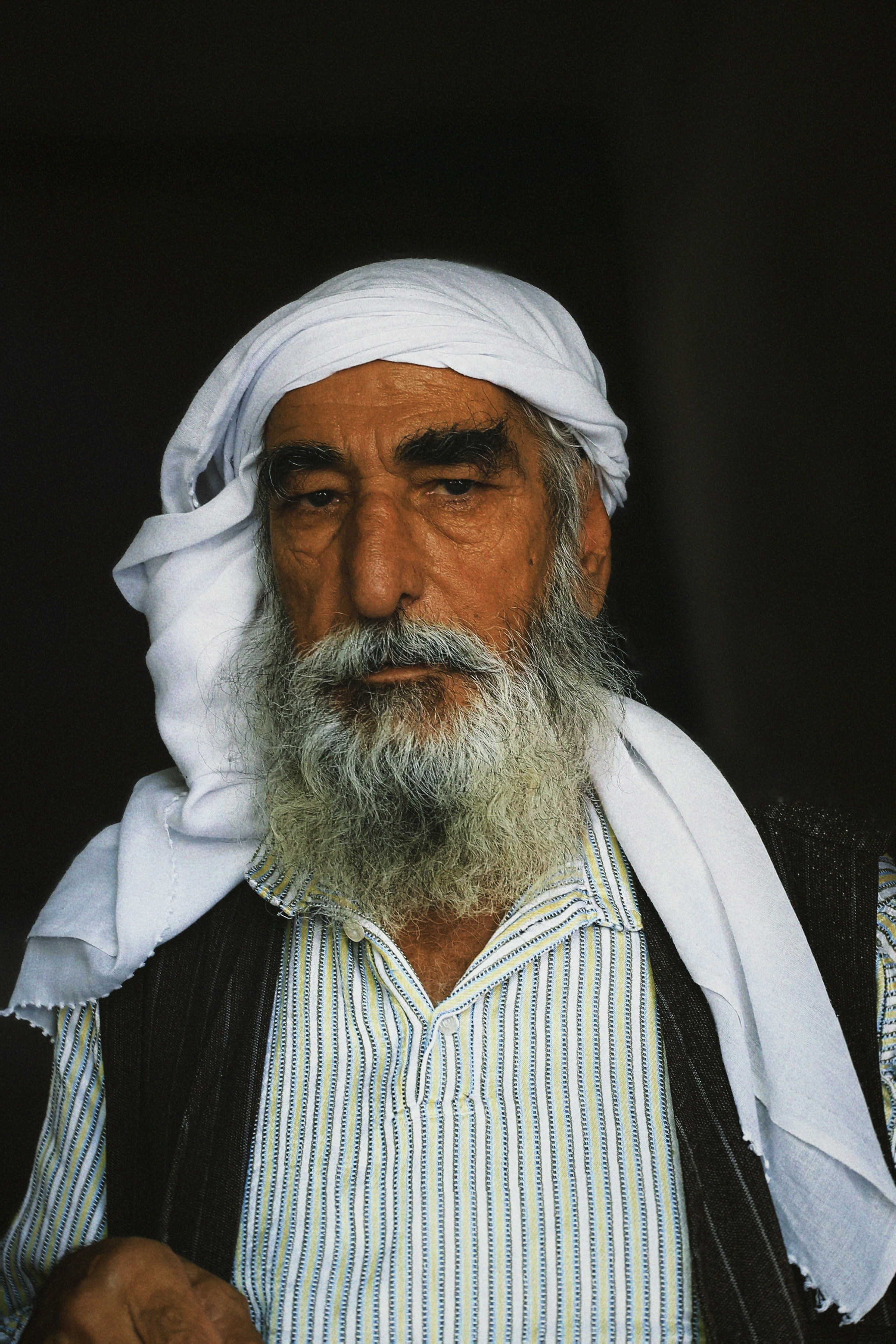 Elderly man with white headscarf and beard