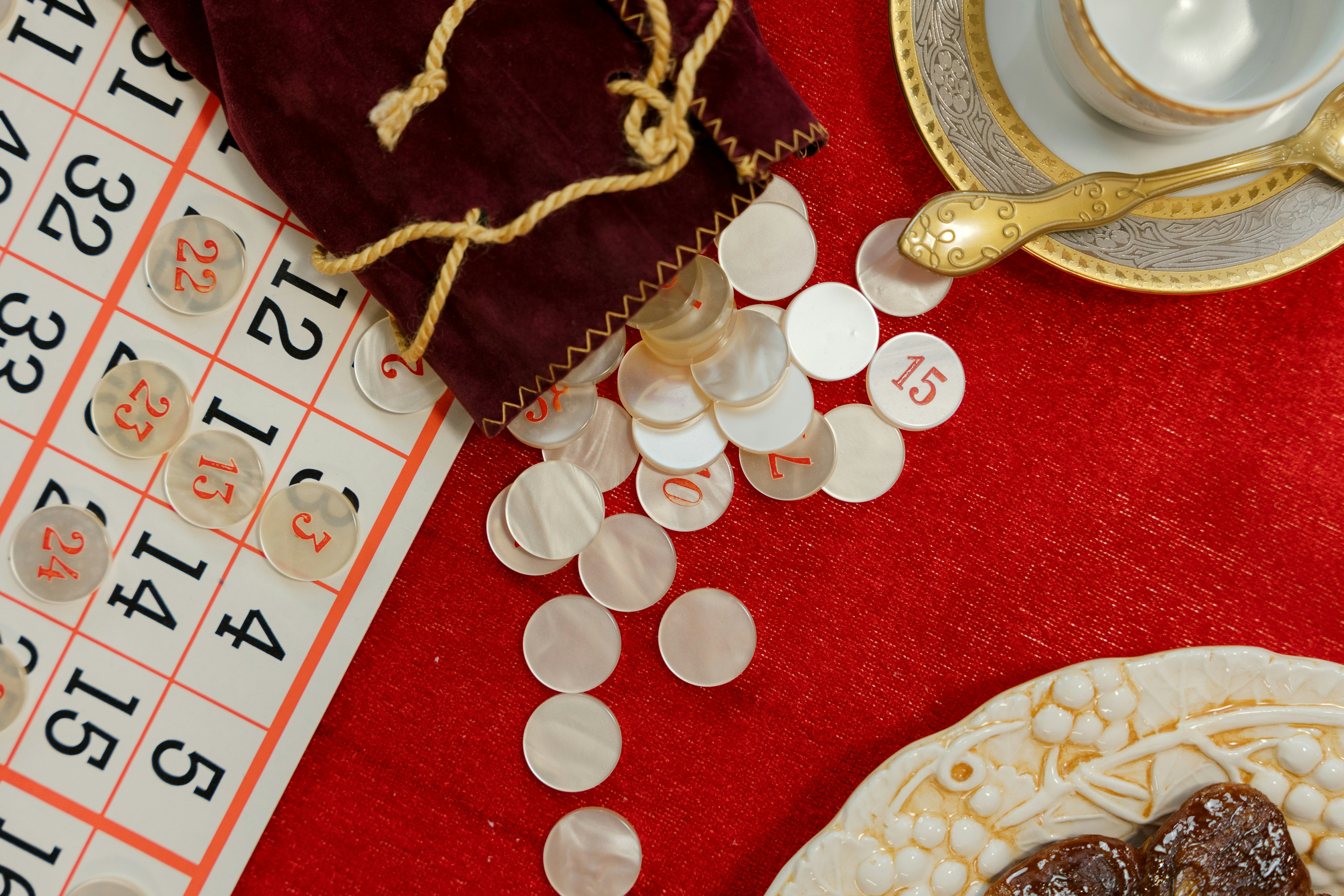 Bingo cards and calling chips spilled from a pouch