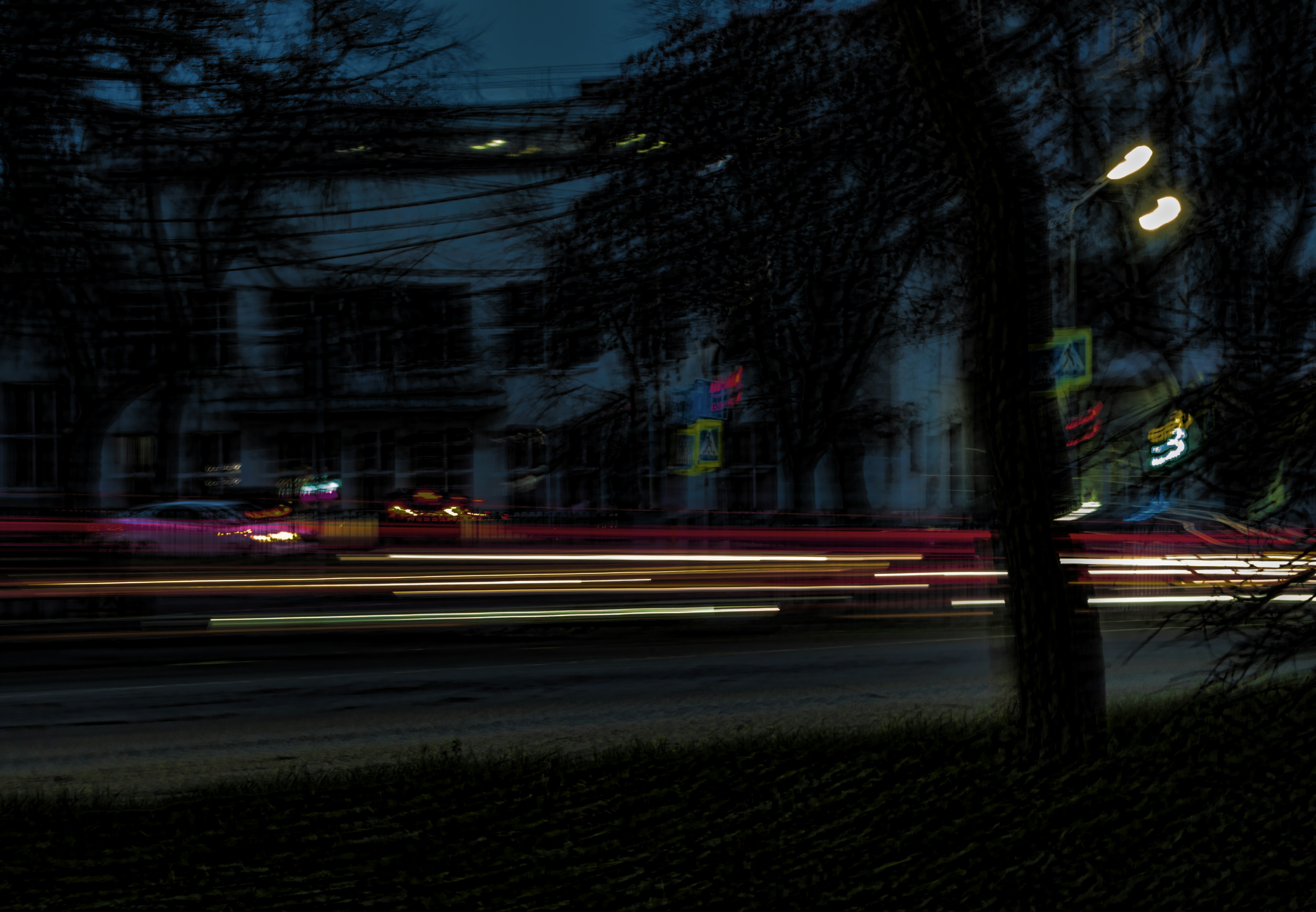Car light trails on a dark street at night