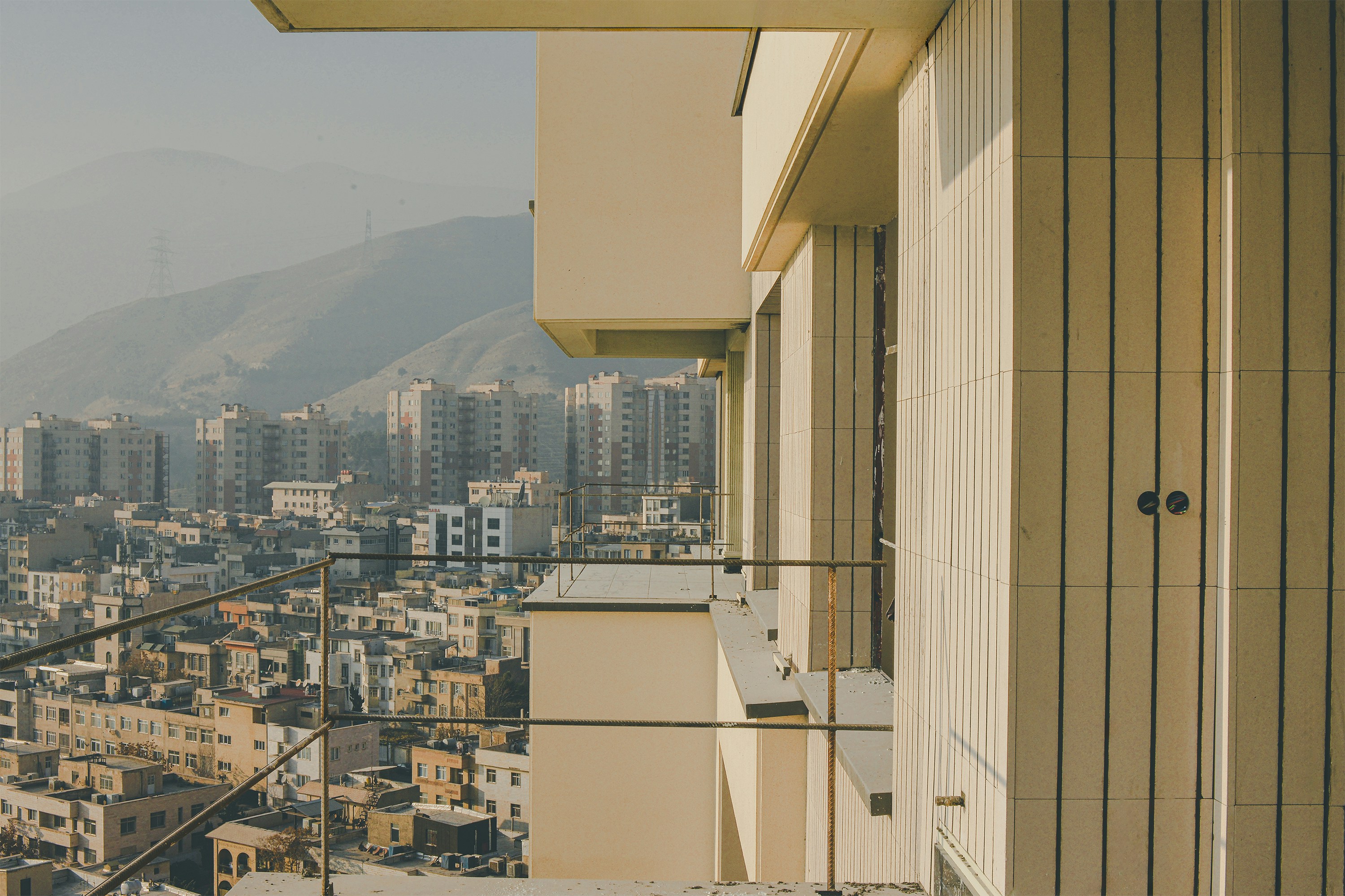 Apartment buildings and mountains in the distance.