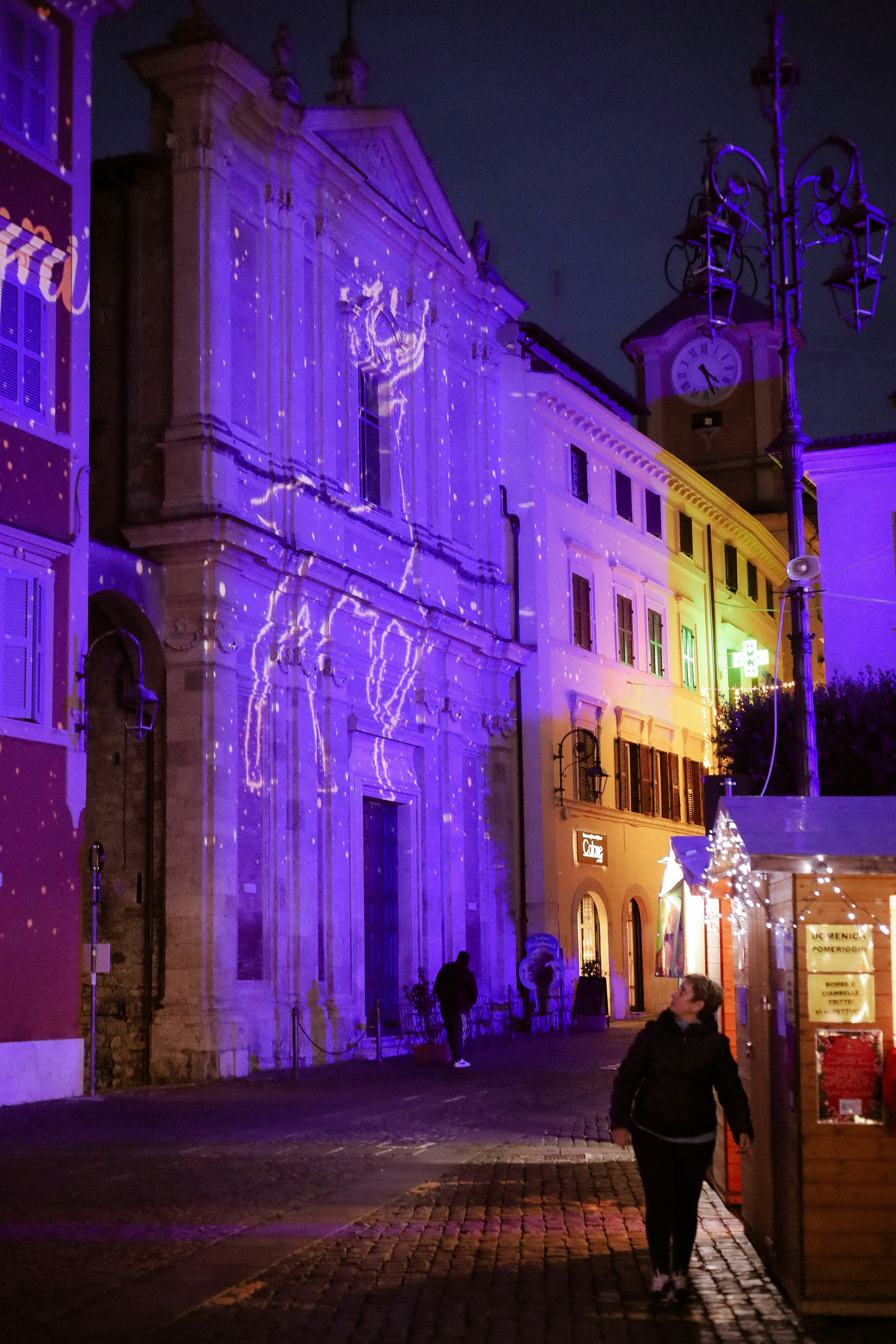 Building illuminated with festive light projections at night.