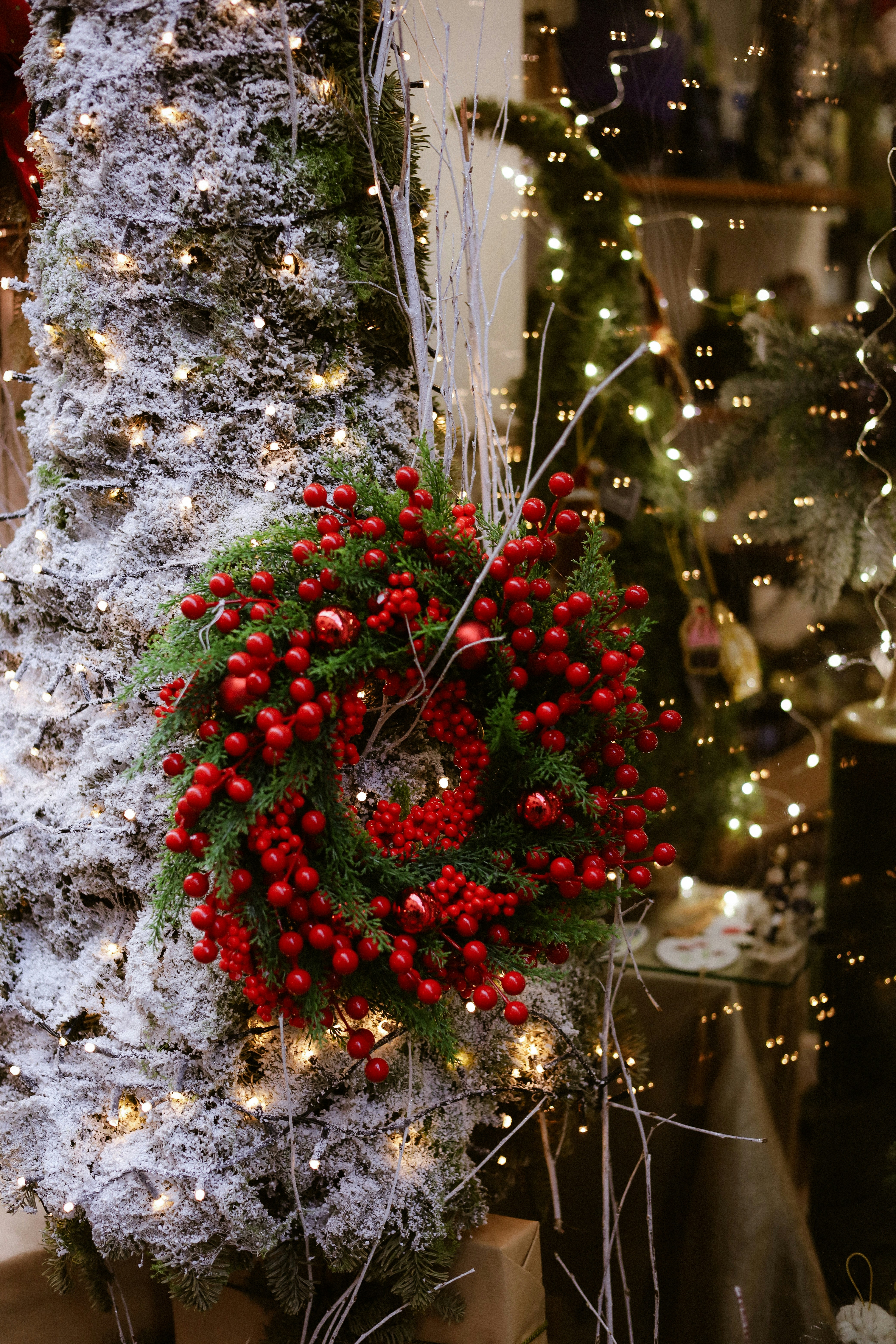 Christmas wreath with red berries on snowy tree