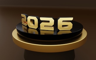 Golden 2026 numbers on a black and gold platform
