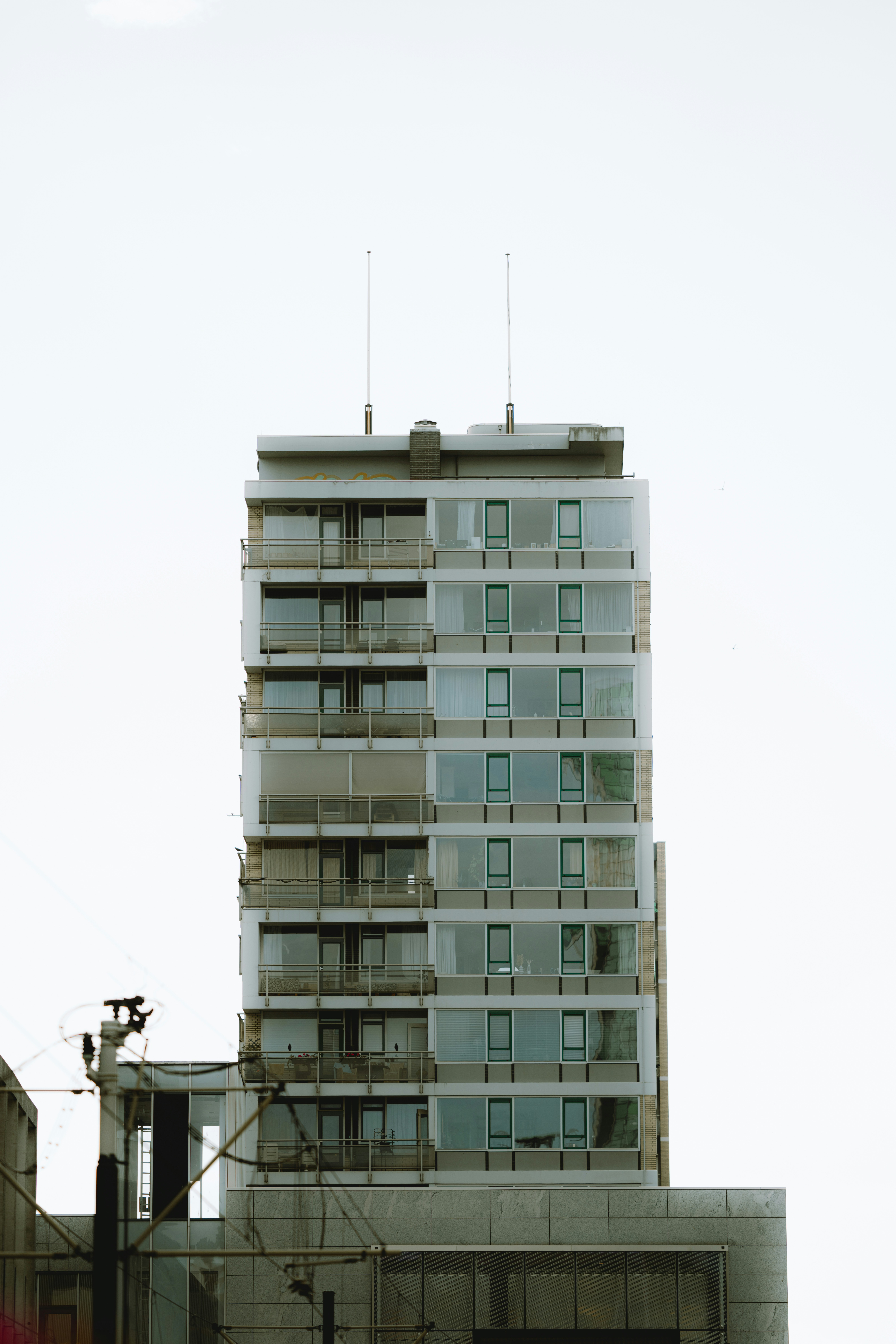Modern glass building against a bright sky.