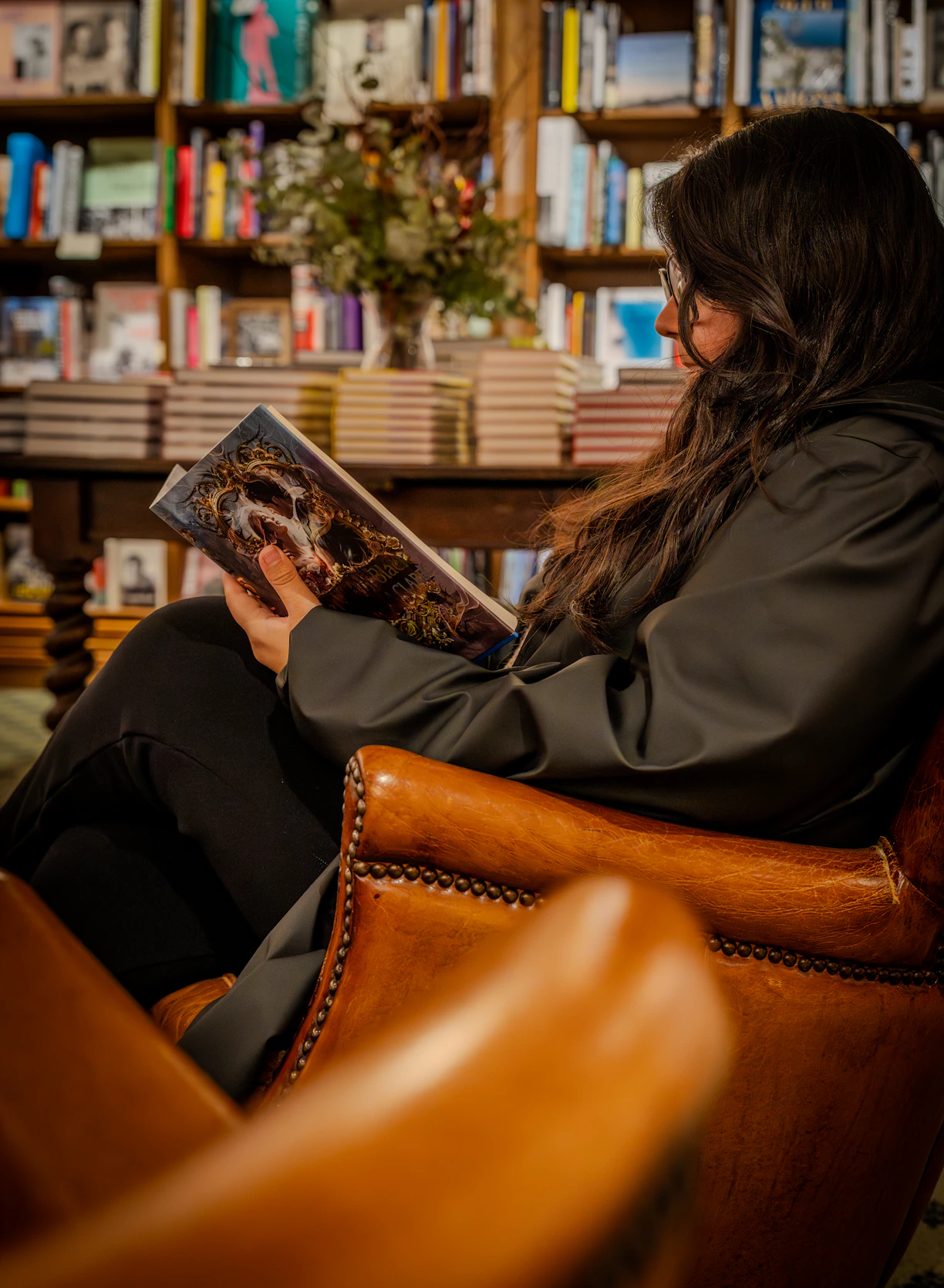 Woman reading a book in a library