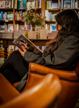 Woman reading a book in a library