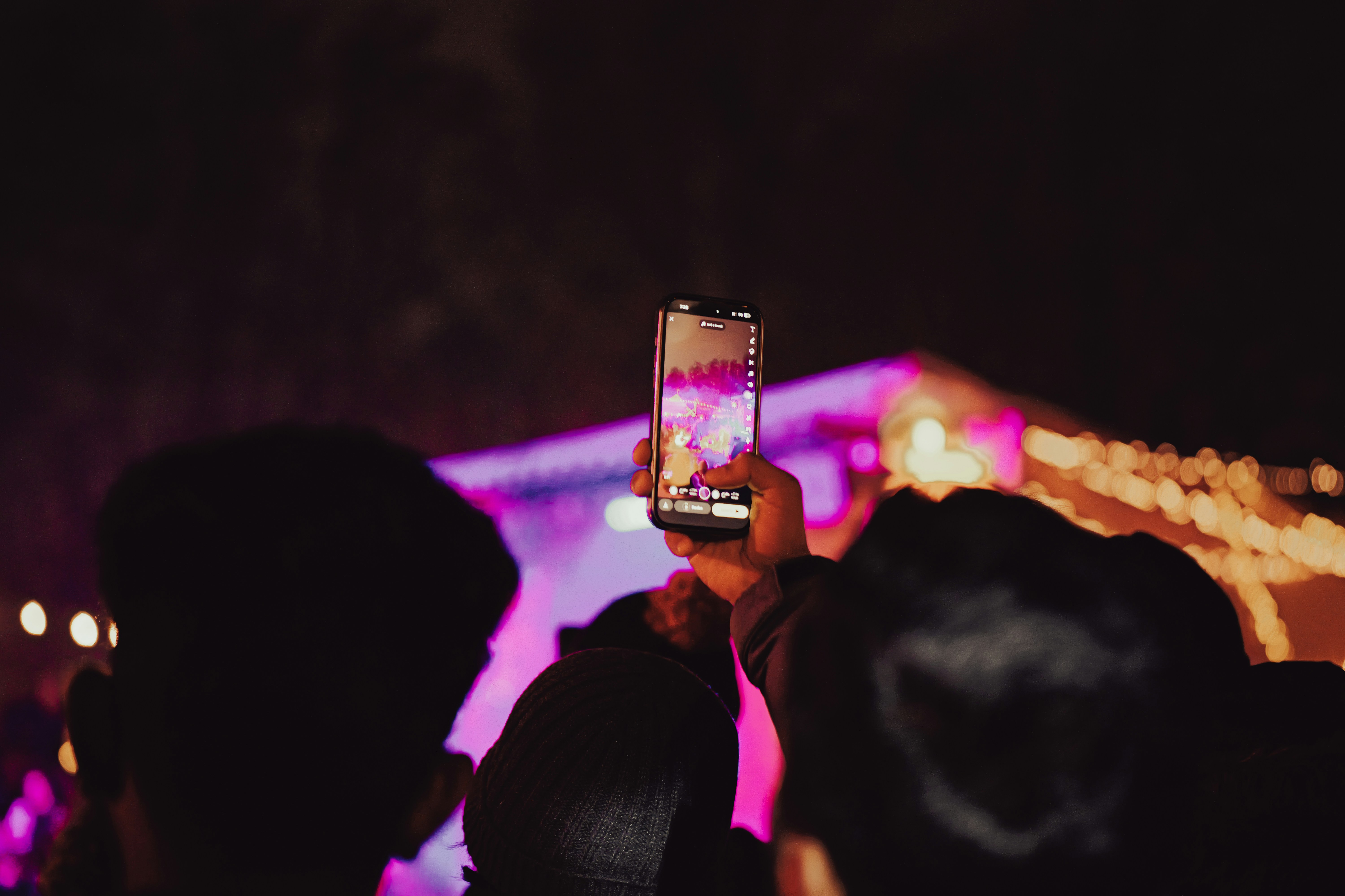 Person records concert with smartphone at night with phone - person-records-concert-with-smartphone-at-night-with-phone-DQYlRVv3eY0