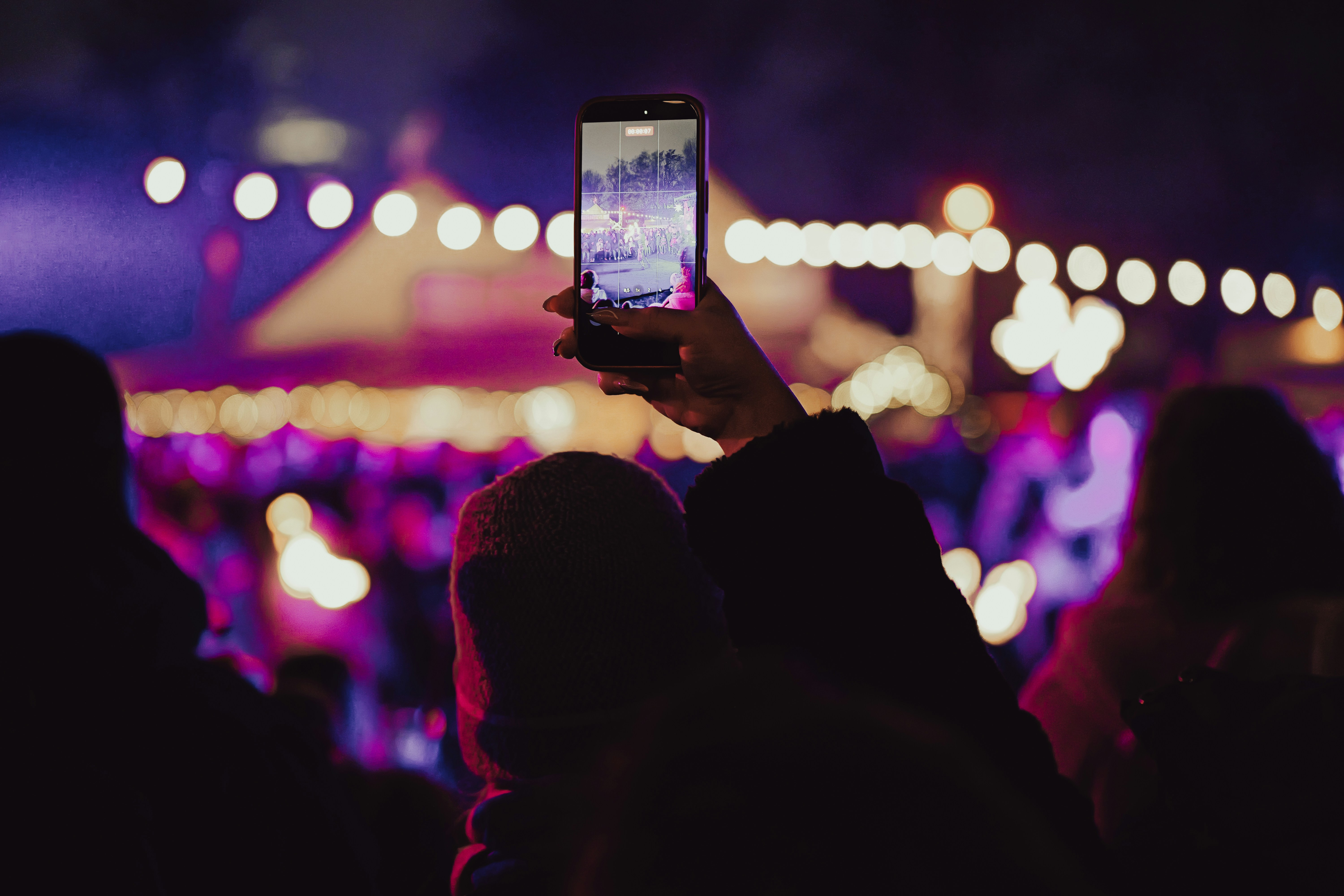 Person records concert with smartphone at night with phone - person-records-concert-with-smartphone-at-night-with-phone-sJbkDXZARV0