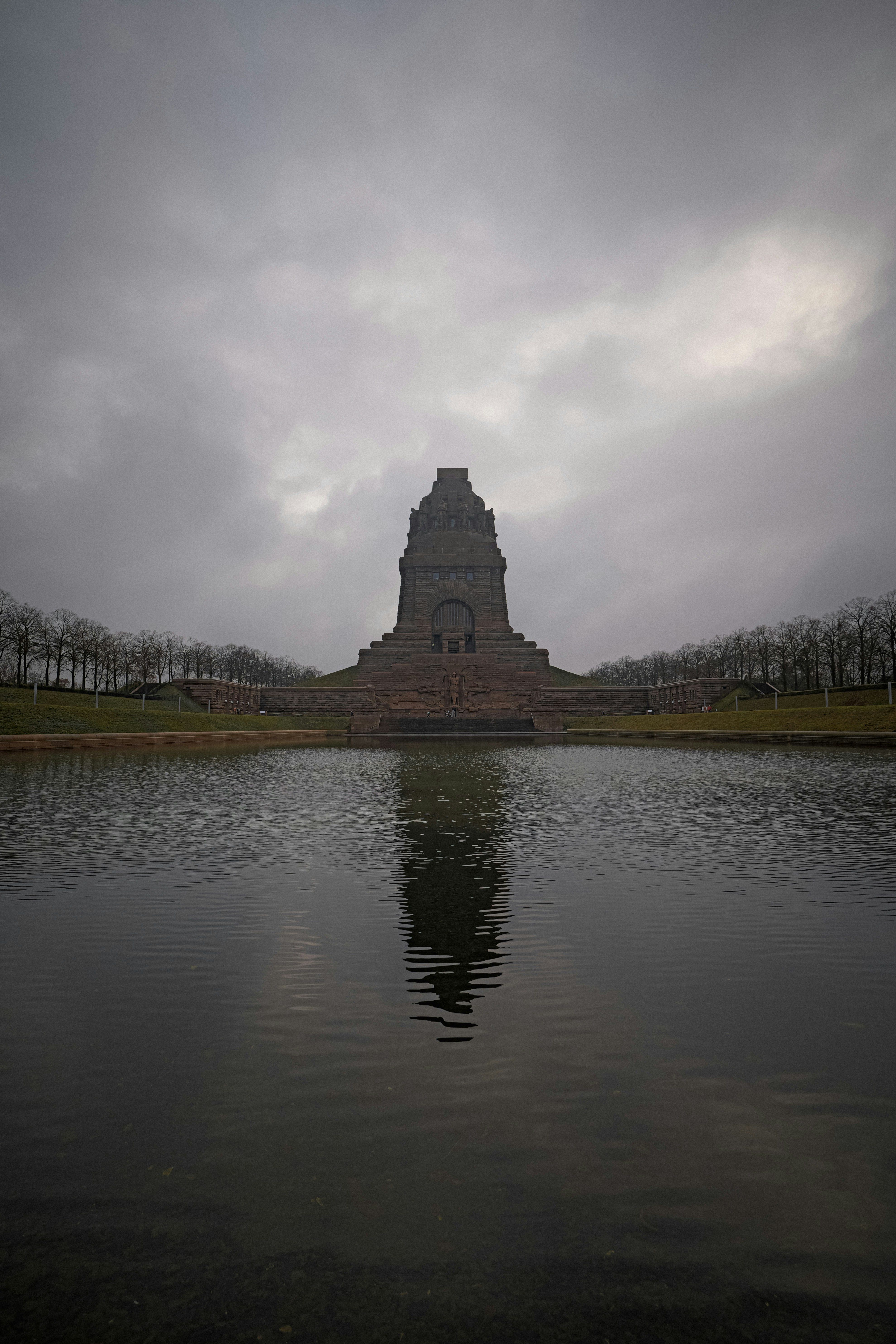 Monument reflected in water under cloudy sky - monument-reflected-in-water-under-cloudy-sky-Sn2aUpo4XWY