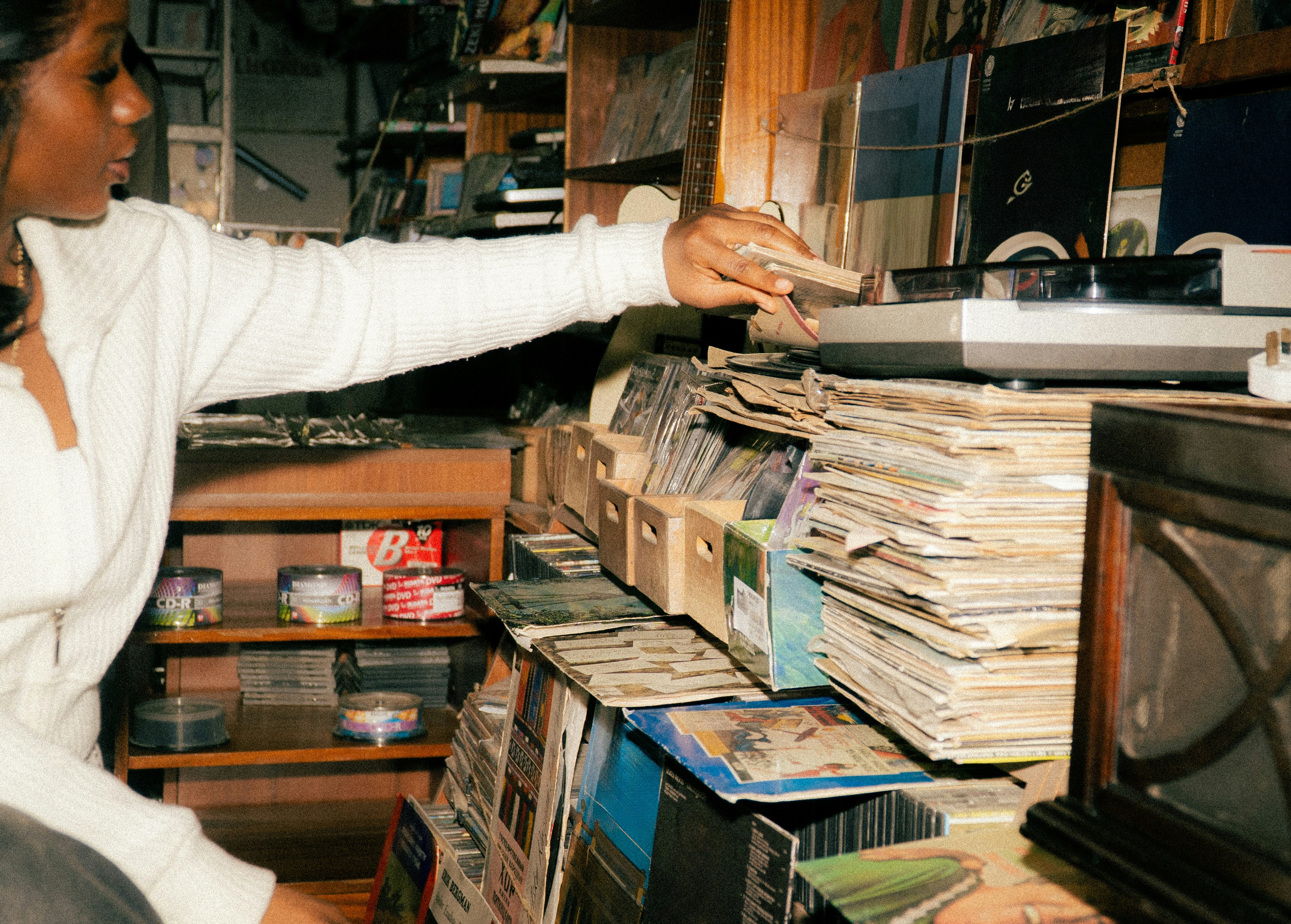 Woman selecting a record from a large collection.