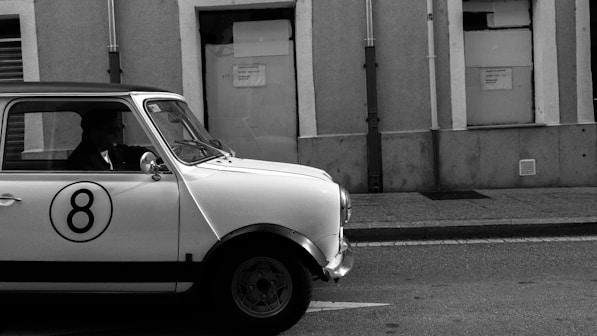 A classic mini car with number eight on door.