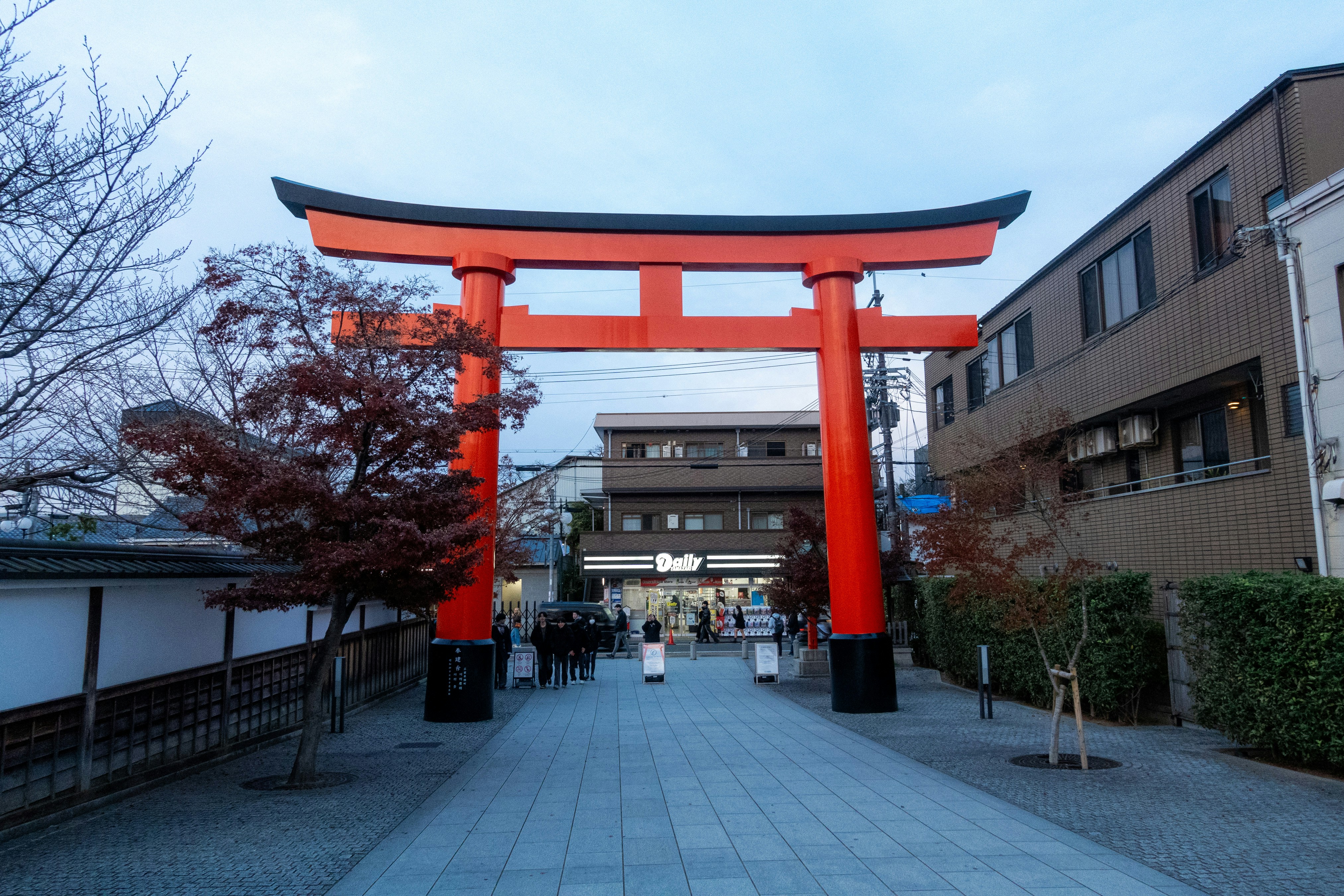 A large red torii gate in a japanese town