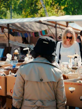 People browsing items at an outdoor market.