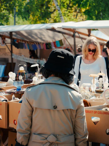 People browsing items at an outdoor market.