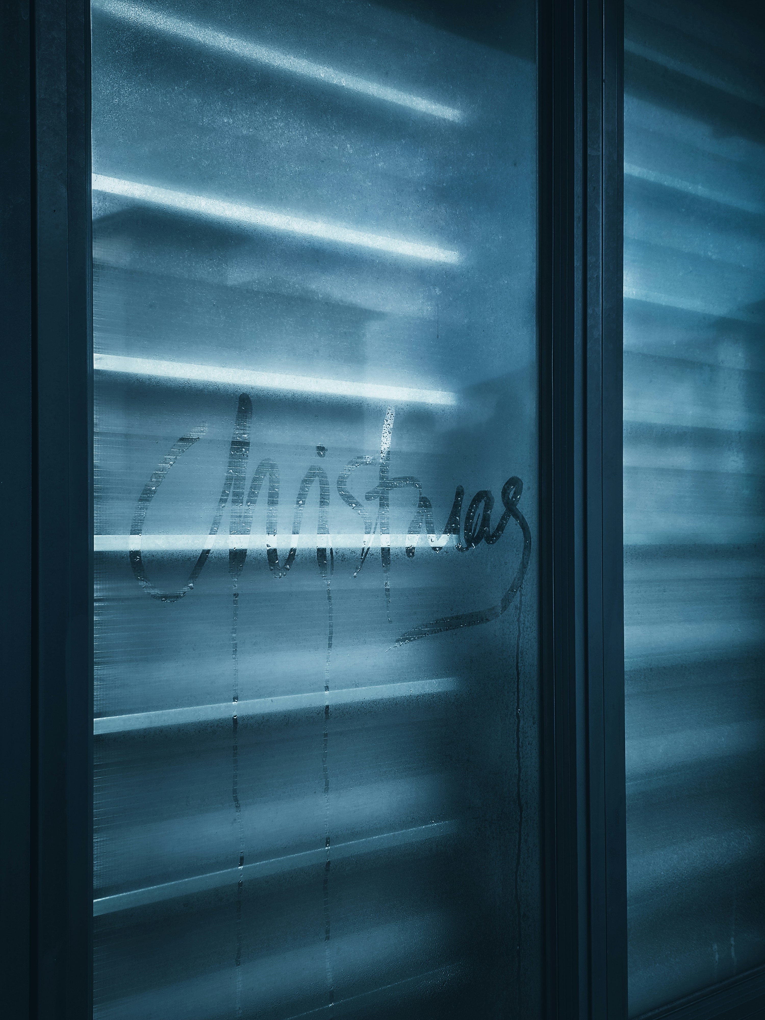 Christmas written on a frosted window