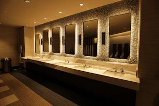 Modern bathroom with multiple sinks and mirrors.