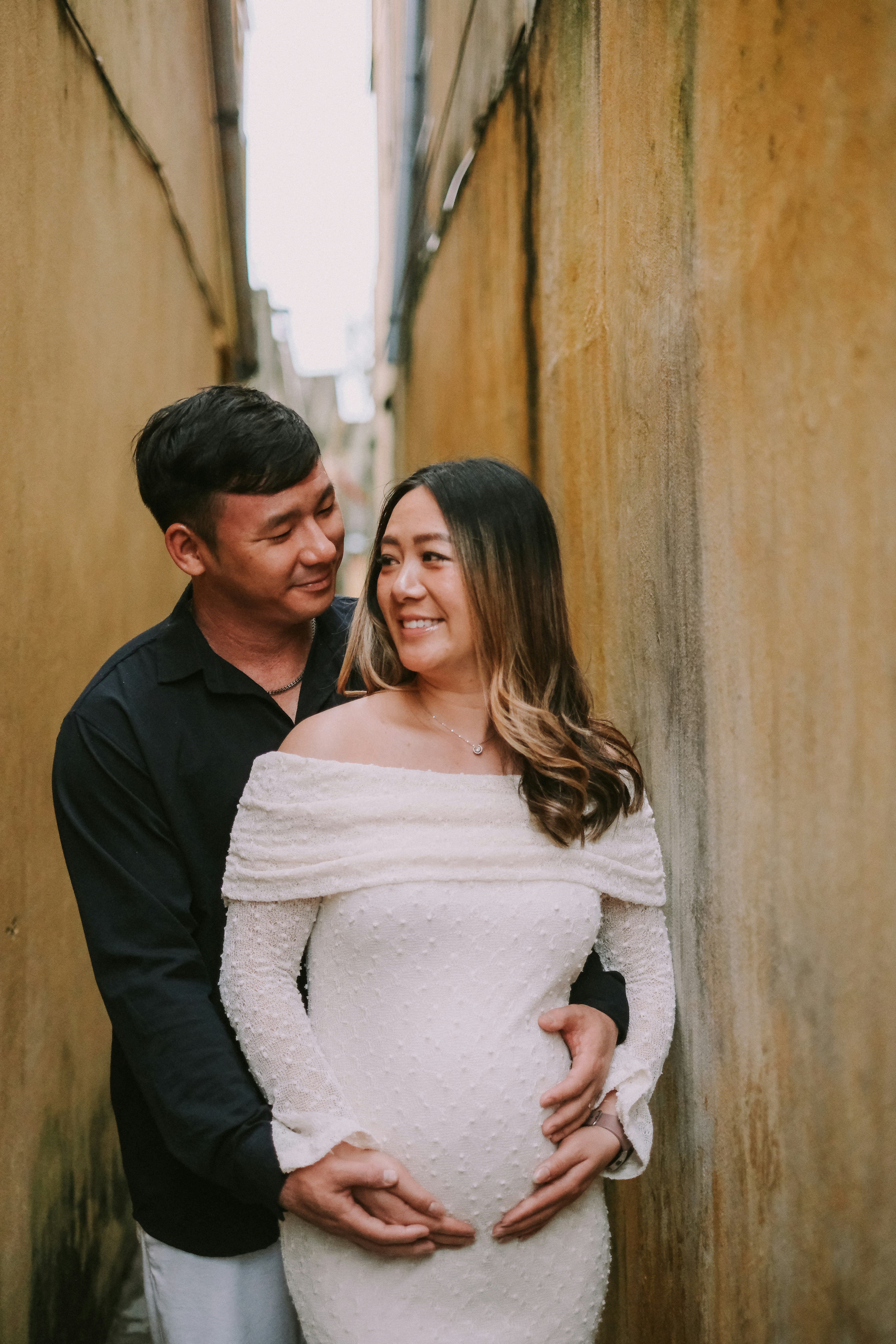 Couple embracing in a narrow alleyway