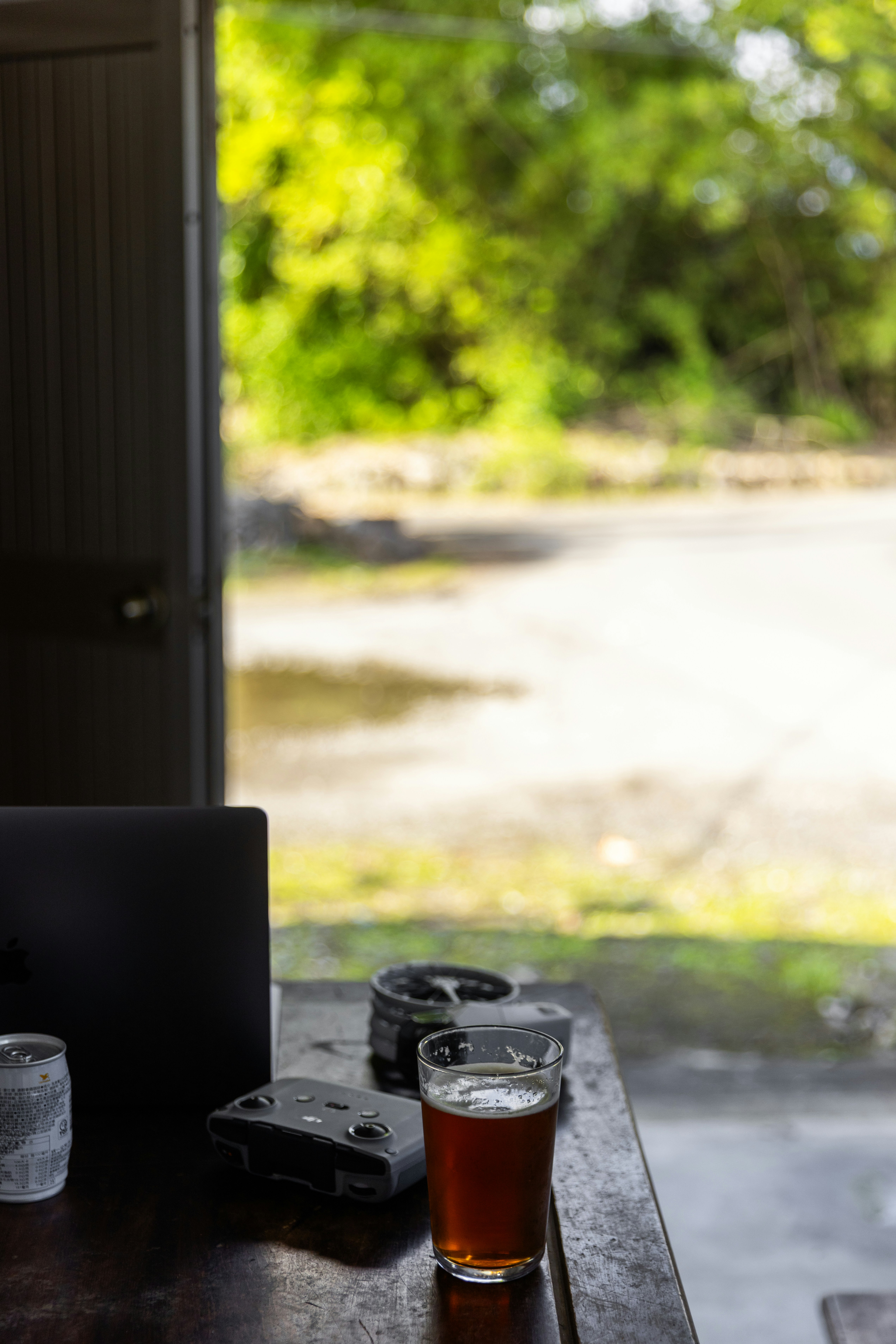 A glass of dark liquid sits on a table.