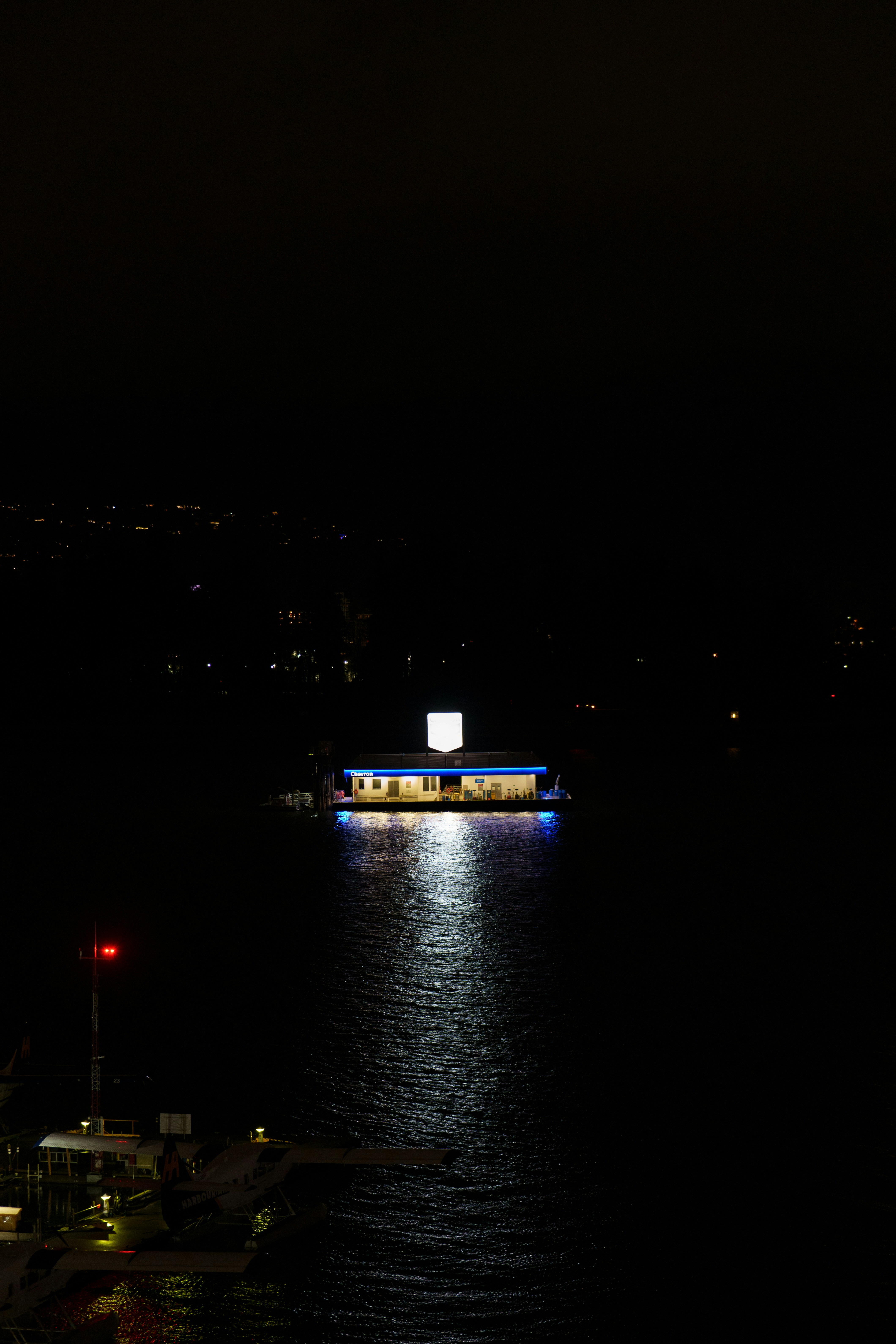 A building on the water at night.
