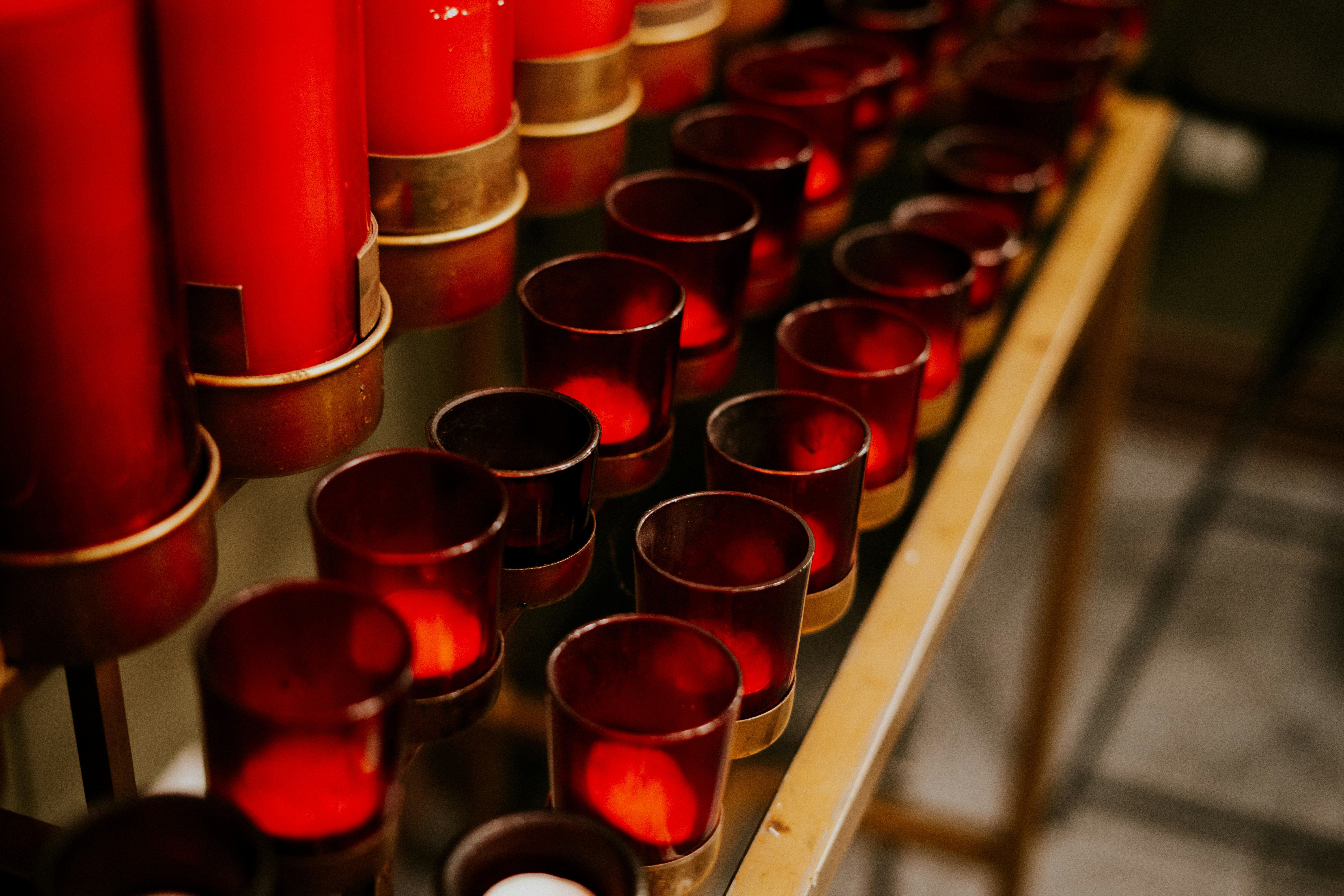 Row of red votive candles in a church