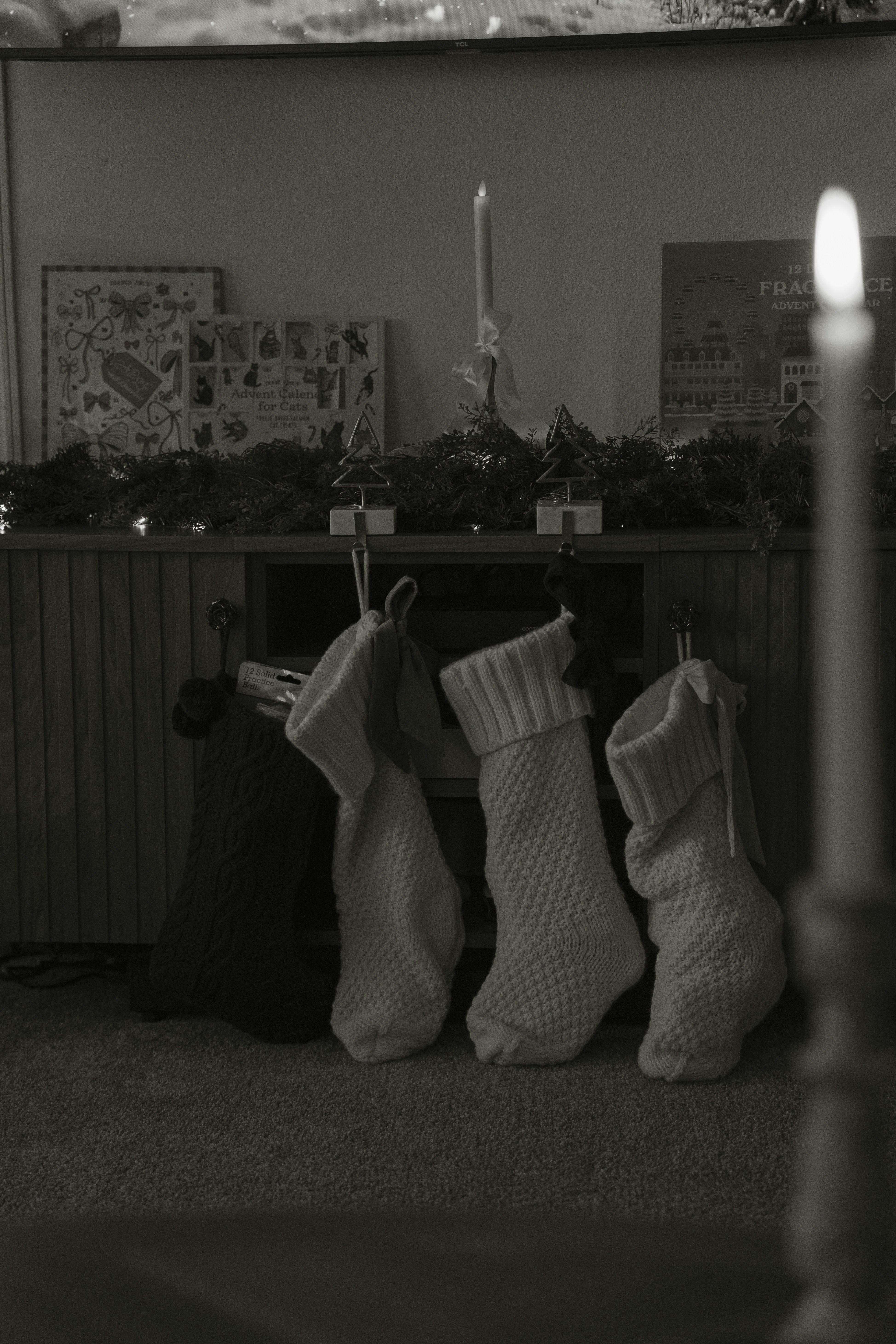 Four christmas stockings hanging by a fireplace.