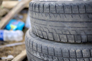 Two old tires stacked on top of each other.