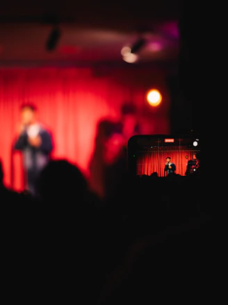 Smartphone recording a live performance on stage.