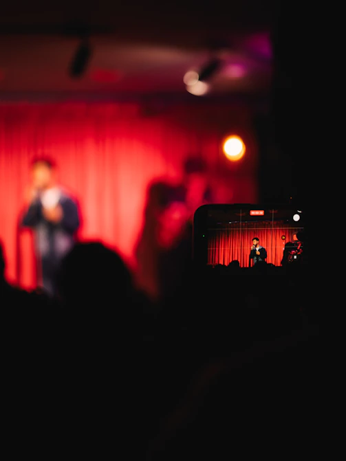 Smartphone recording a live performance on stage.