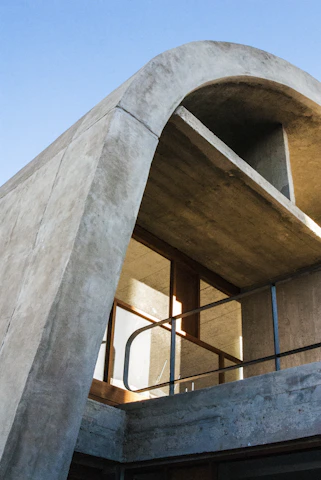 Modern concrete building with curved roof and windows