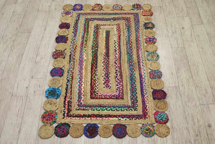 Colourful braided rug with a circular border photographed on a wooden floor