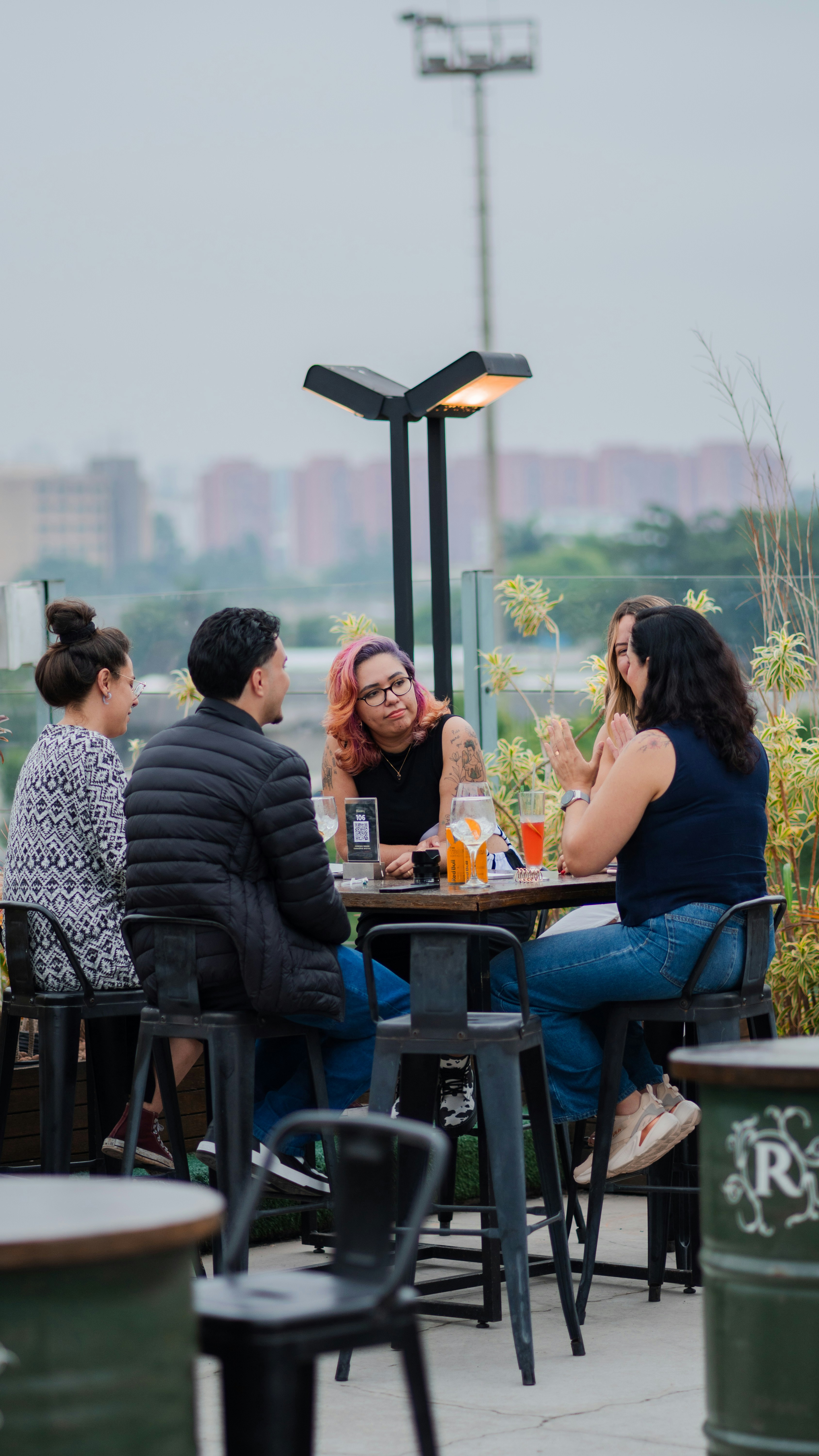 Friends gathered around a table at an outdoor cafe.