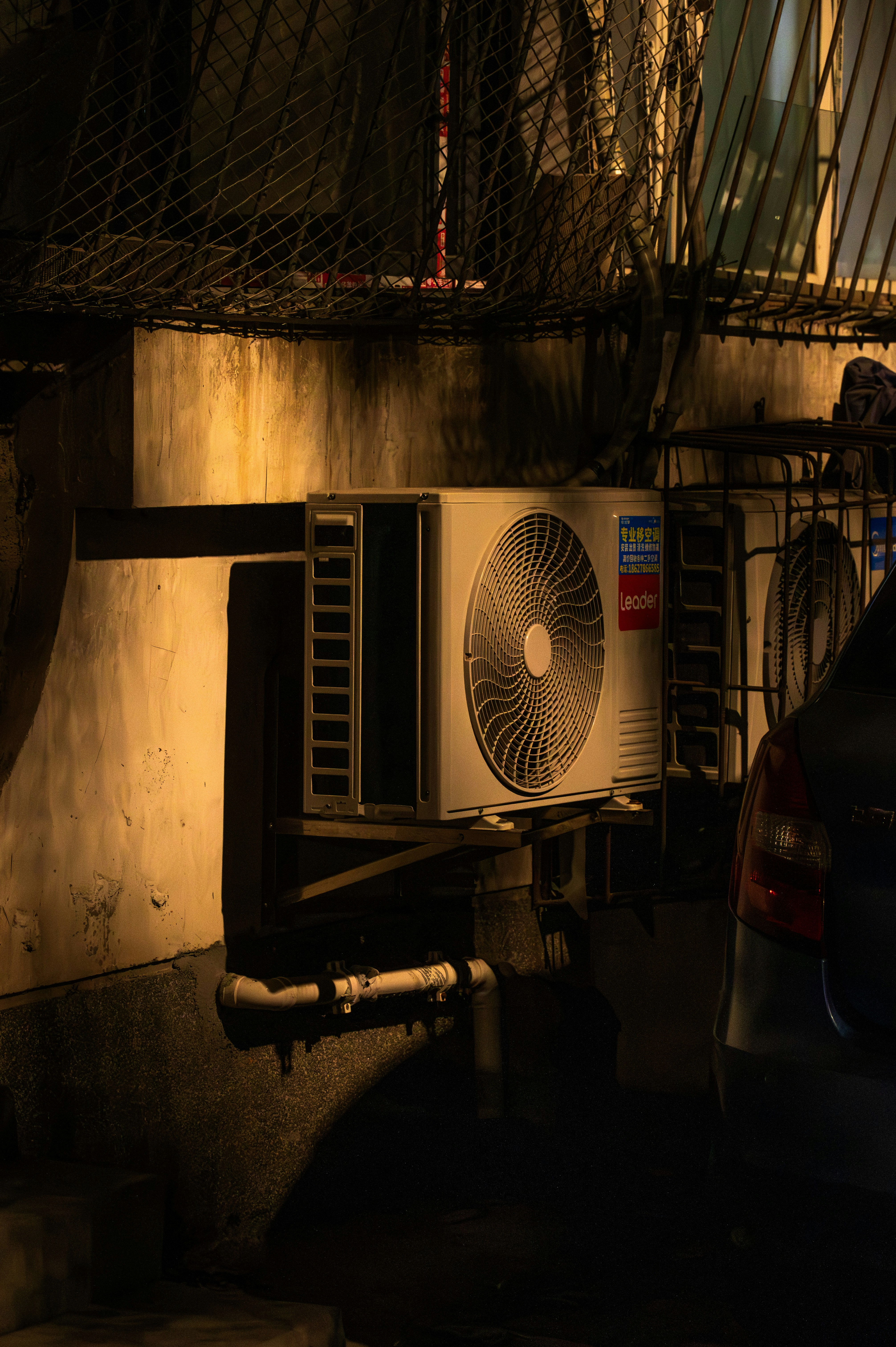 An outdoor air conditioning unit mounted on a wall