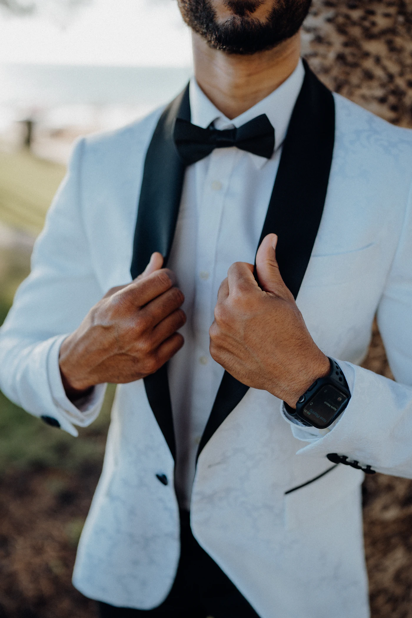 A man in an ivory dinner jacket