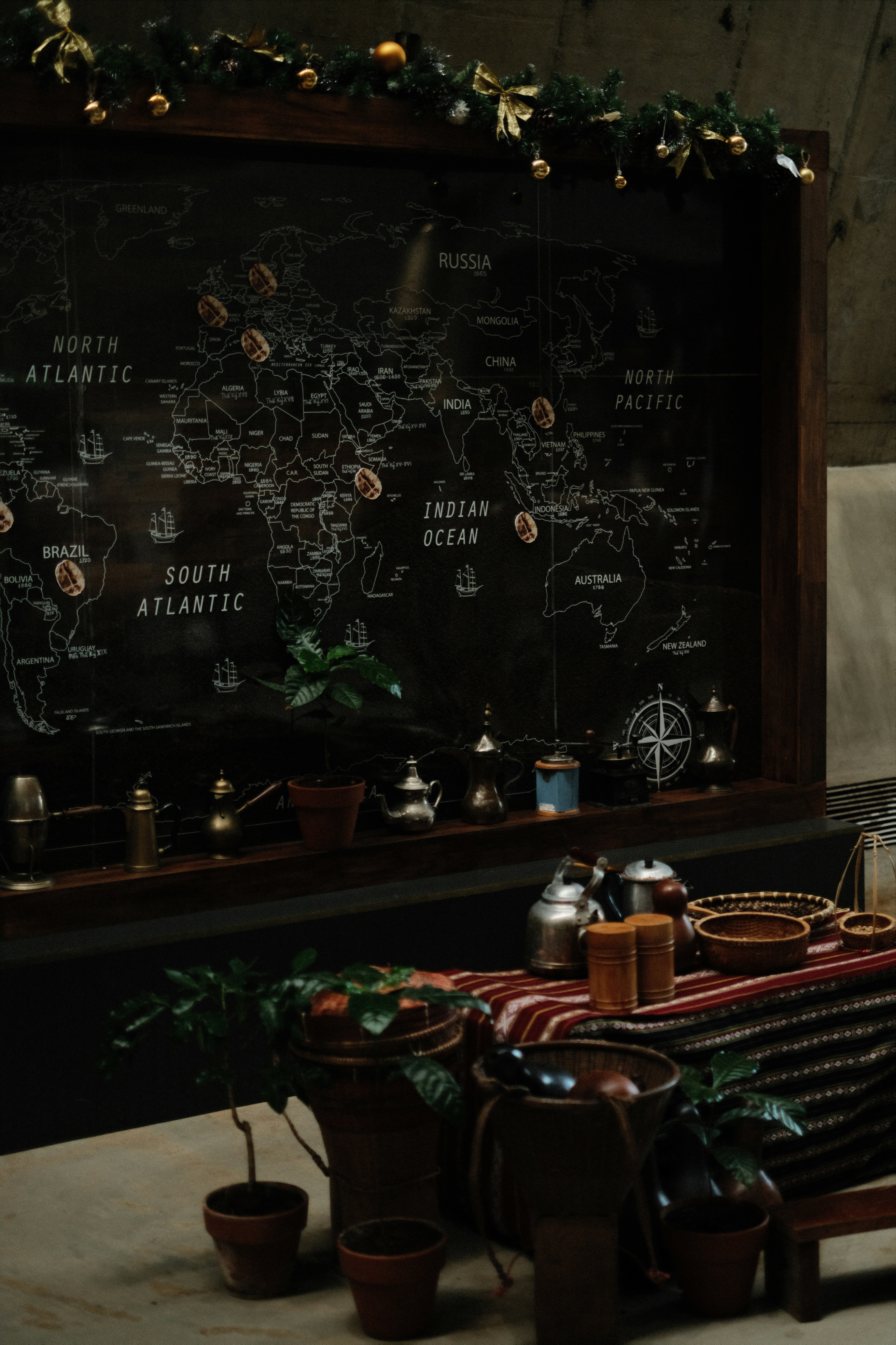 World map decorated with coffee beans and plants.