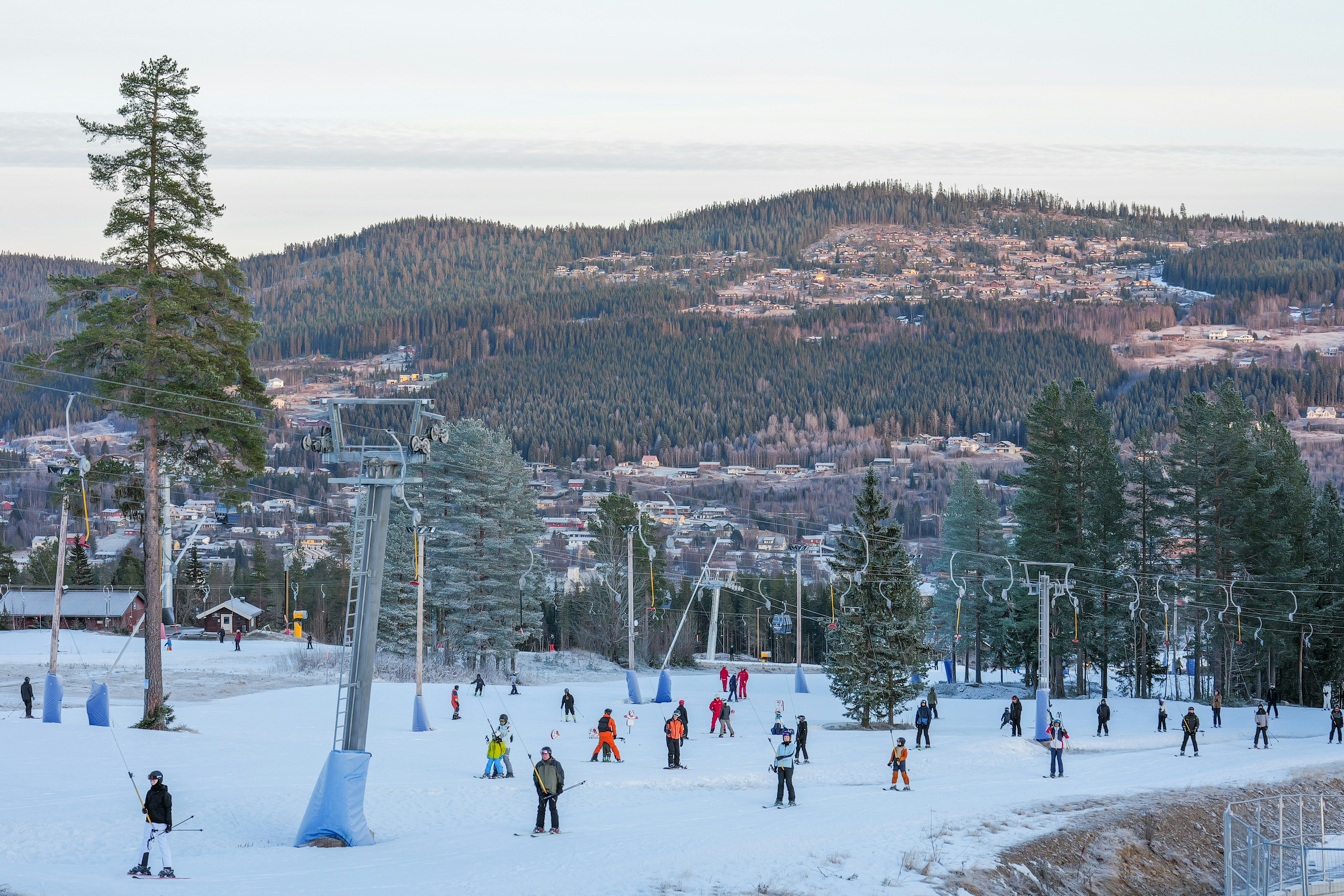 Skiers and snowboarders on a snowy mountain slope.