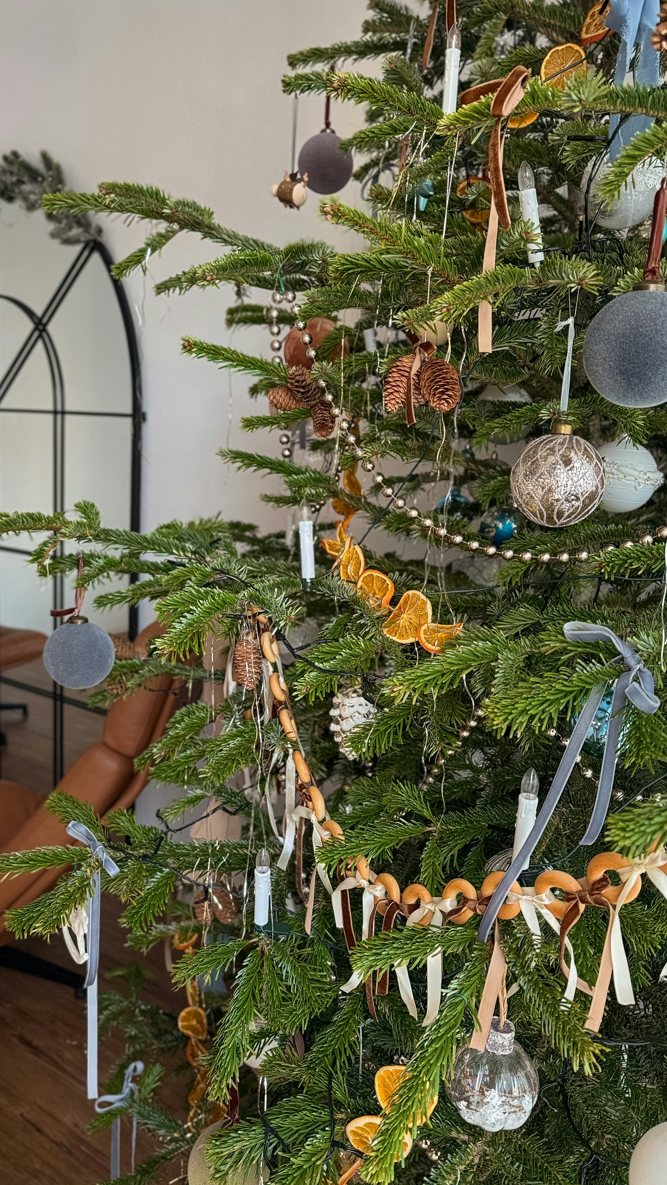 A decorated christmas tree with natural ornaments.