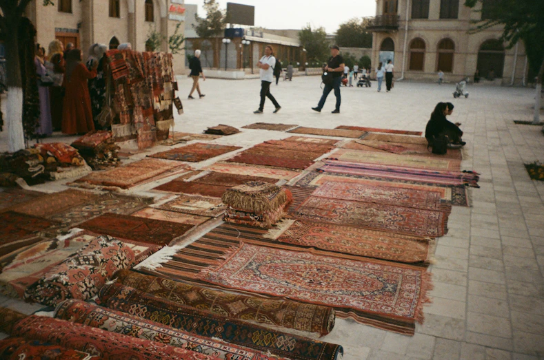 Rugs displayed for sale in an outdoor market