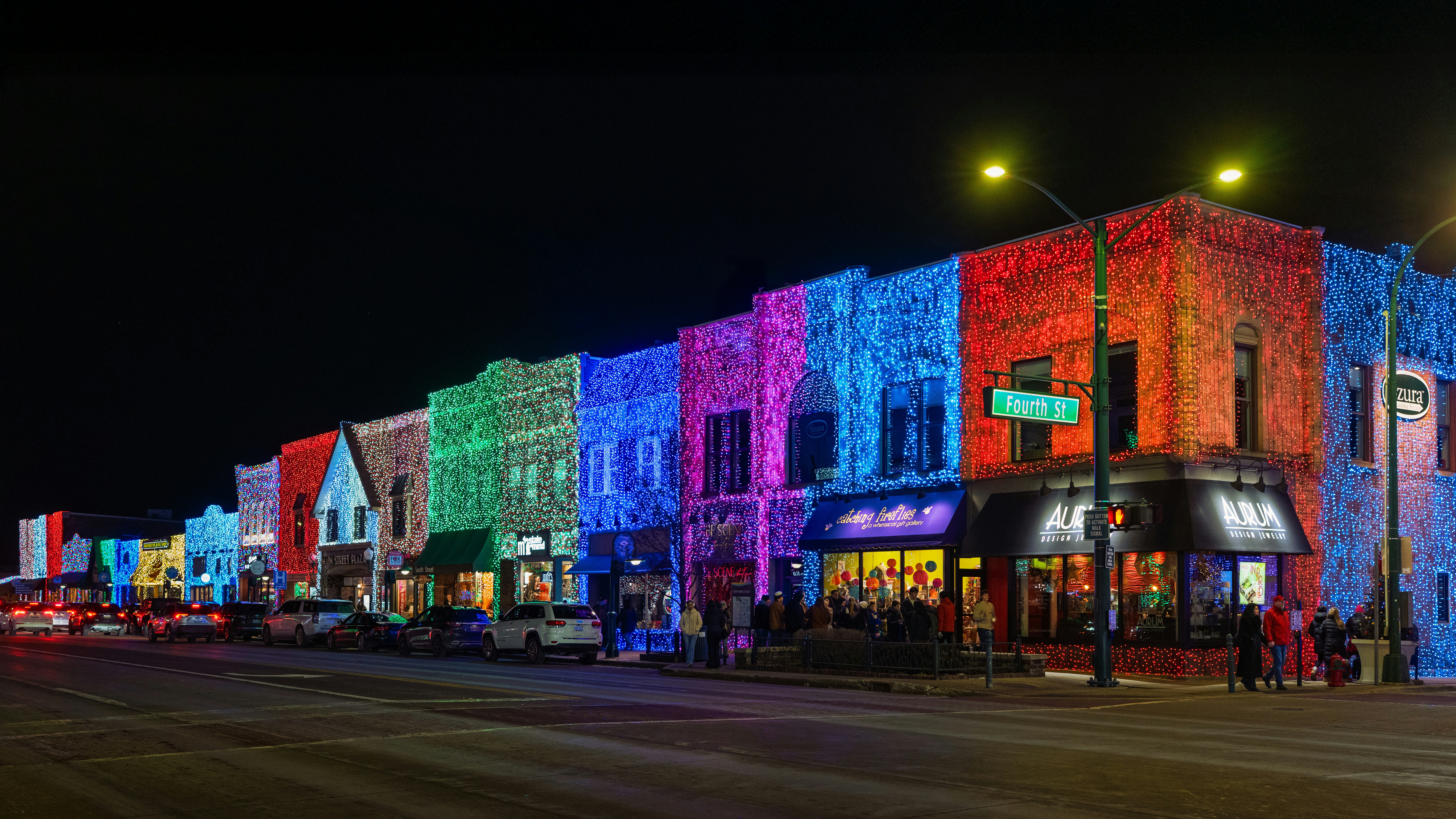 Buildings decorated with colorful lights at night.