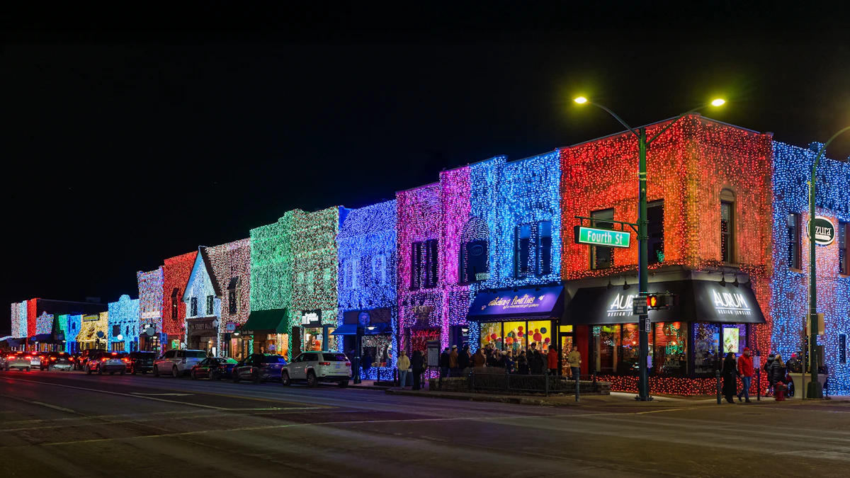 Row of small-town storefronts lit in different colours along a street at night