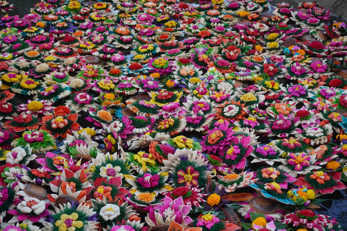Colourful flowered krathong floating on the water at Loy Krathong
