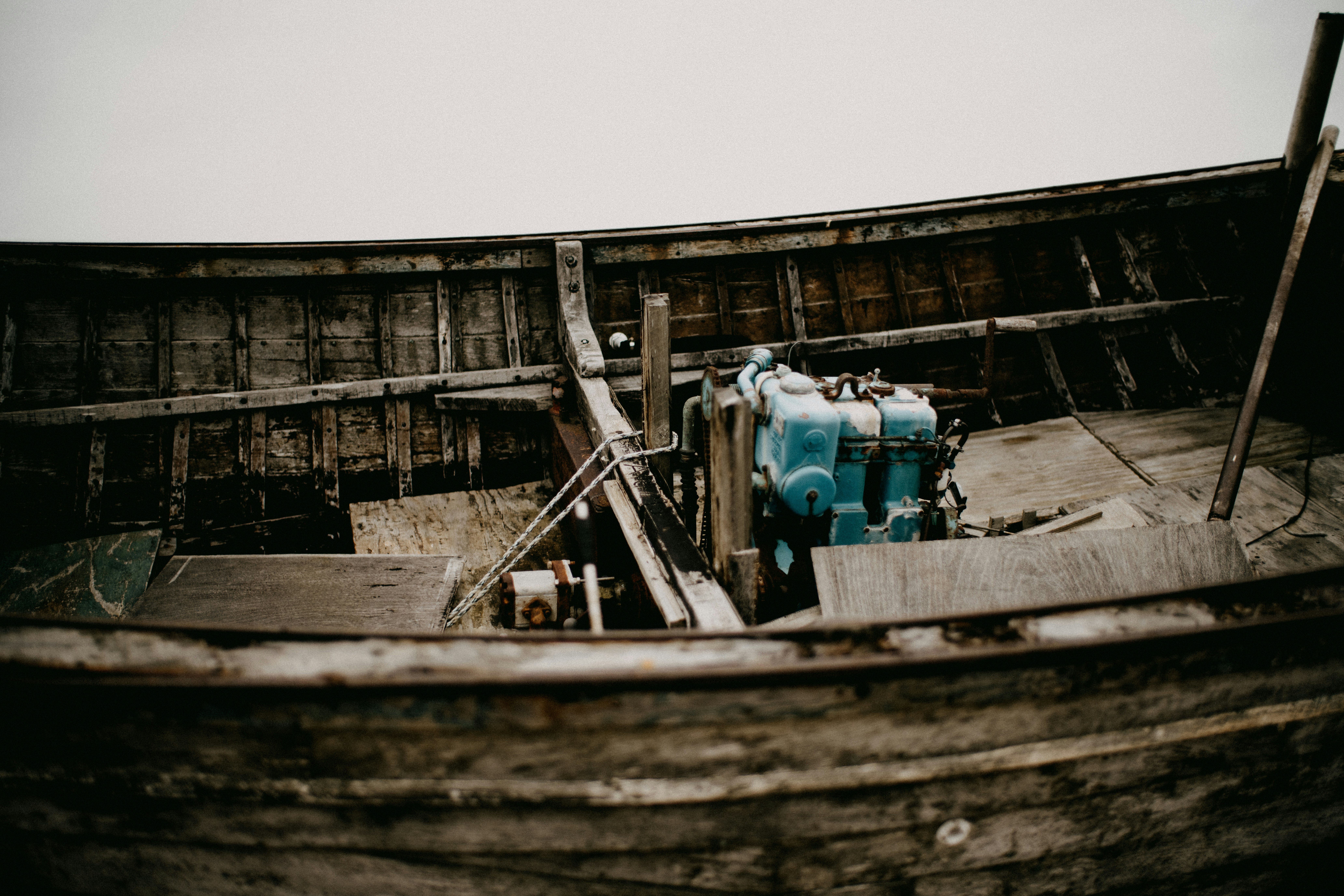 Old wooden boat interior with blue engine