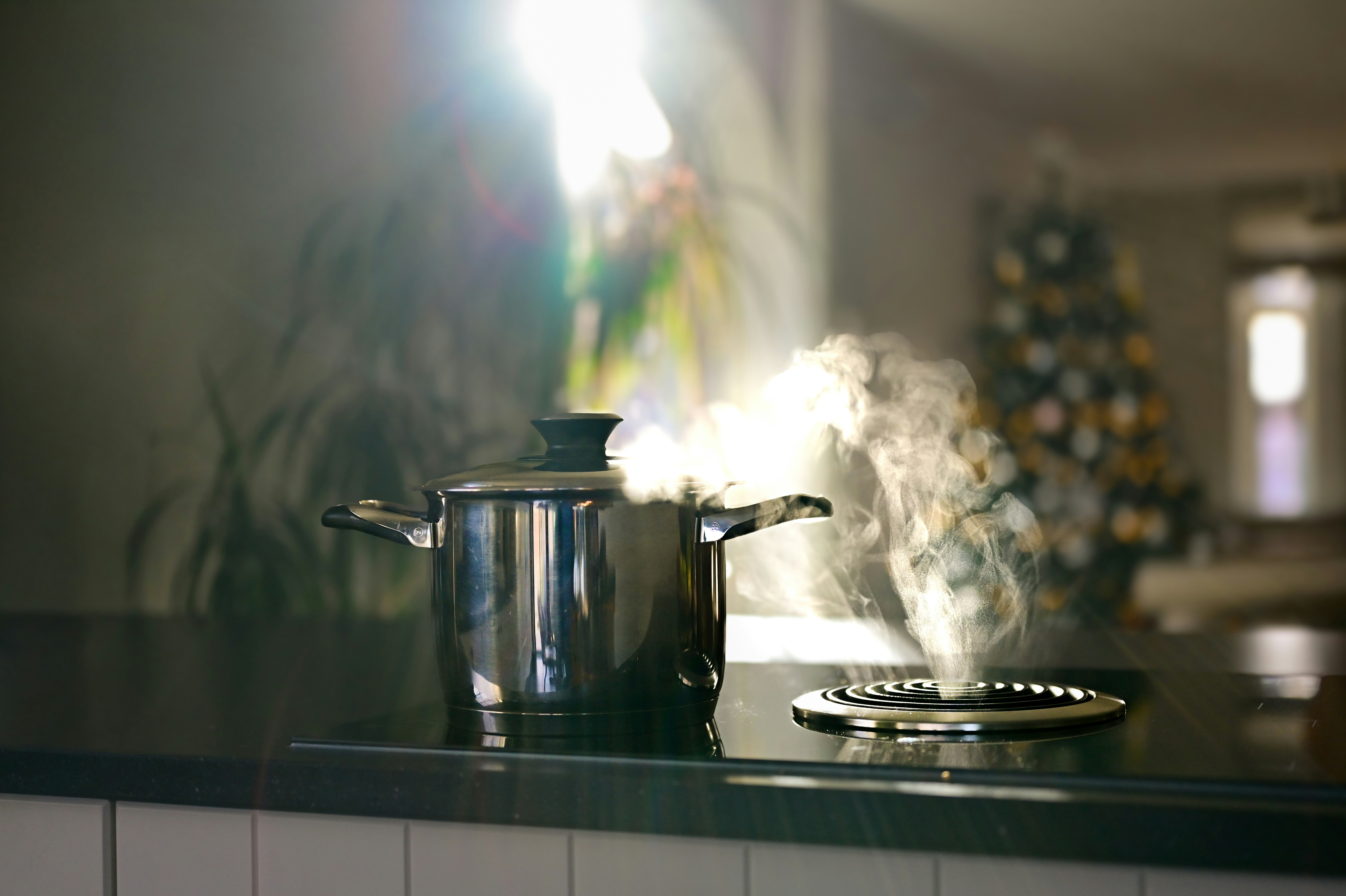 Steaming pot on stovetop with bright light