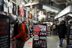 People browsing music and merchandise in a store.